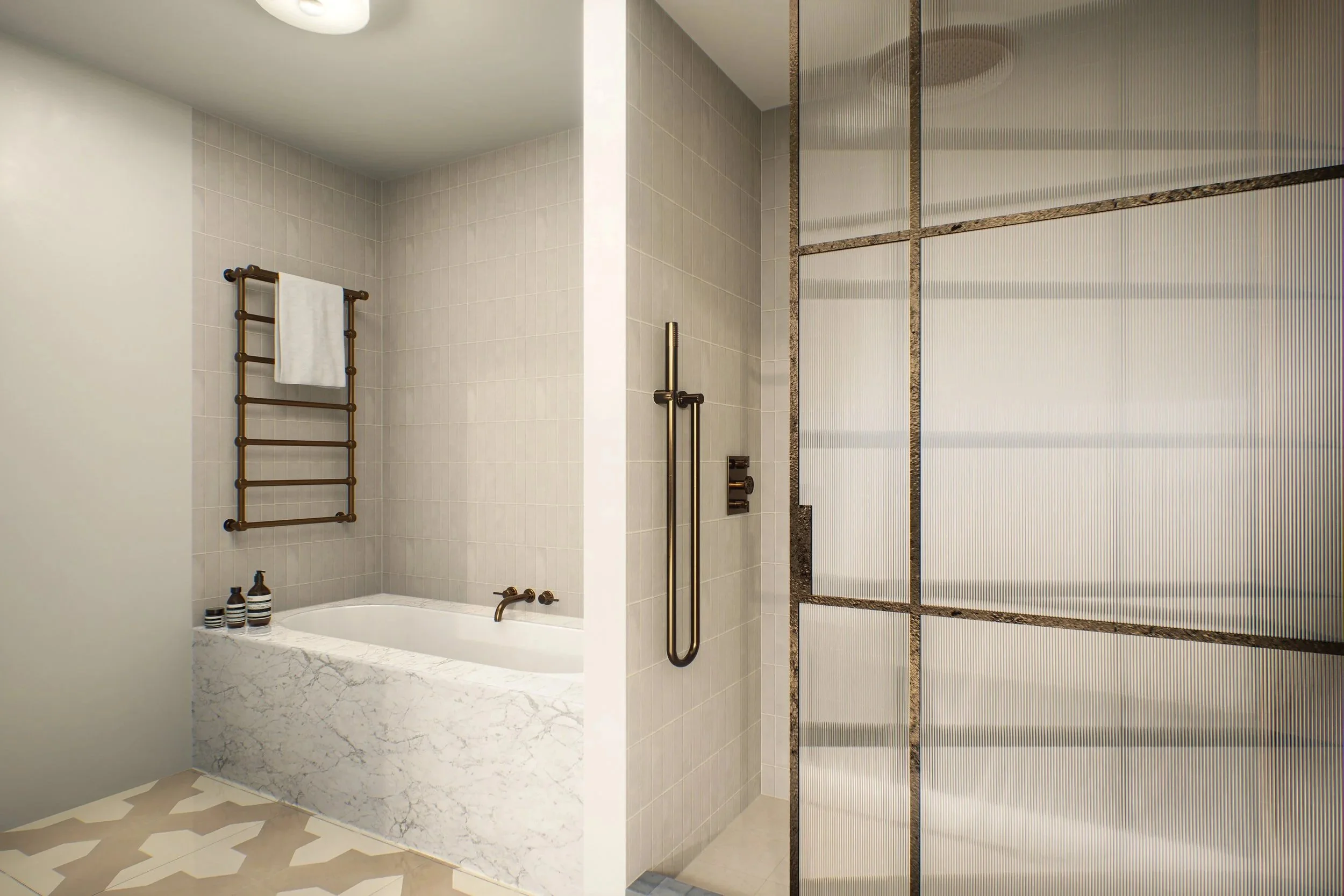 Modern bathroom with a bathtub, white marble exterior, bronze fixtures, a wall-mounted towel rack, bottles on the edge of the tub, and a separated shower area with textured glass partition and bronze framing.