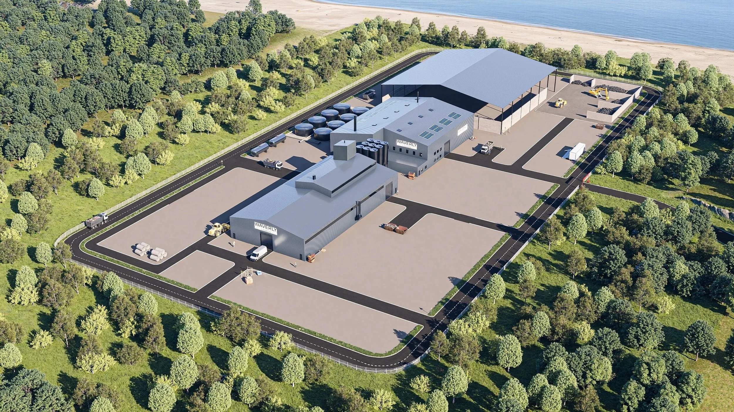 Aerial view of an industrial facility named Waverly surrounded by greenery, with multiple buildings, parking areas, and a road network, located near a coastline with a sandy beach.