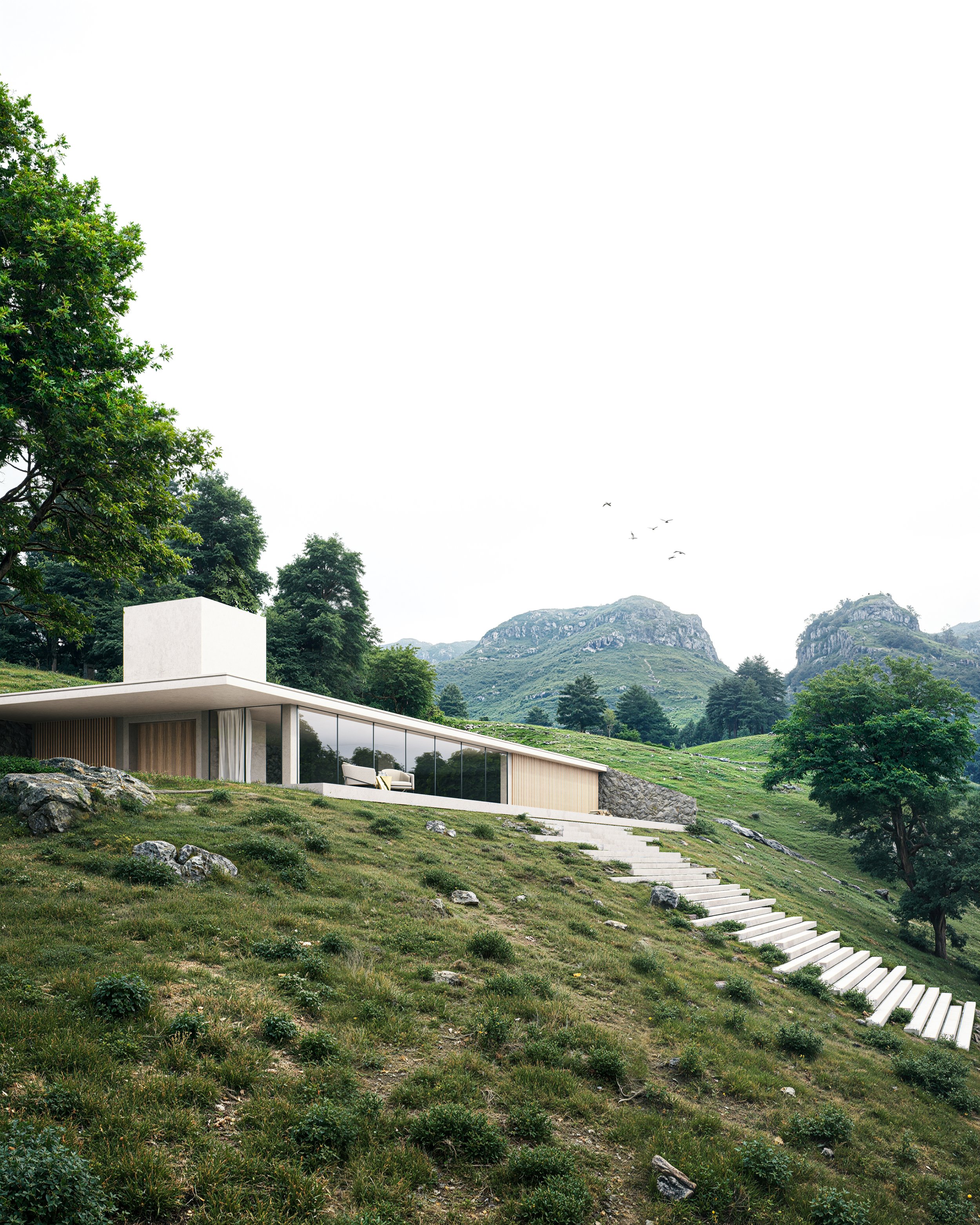 Modern house with large glass windows situated on a grassy hillside with rocky terrain and trees, mountains in the background, and stairs leading up to the house.