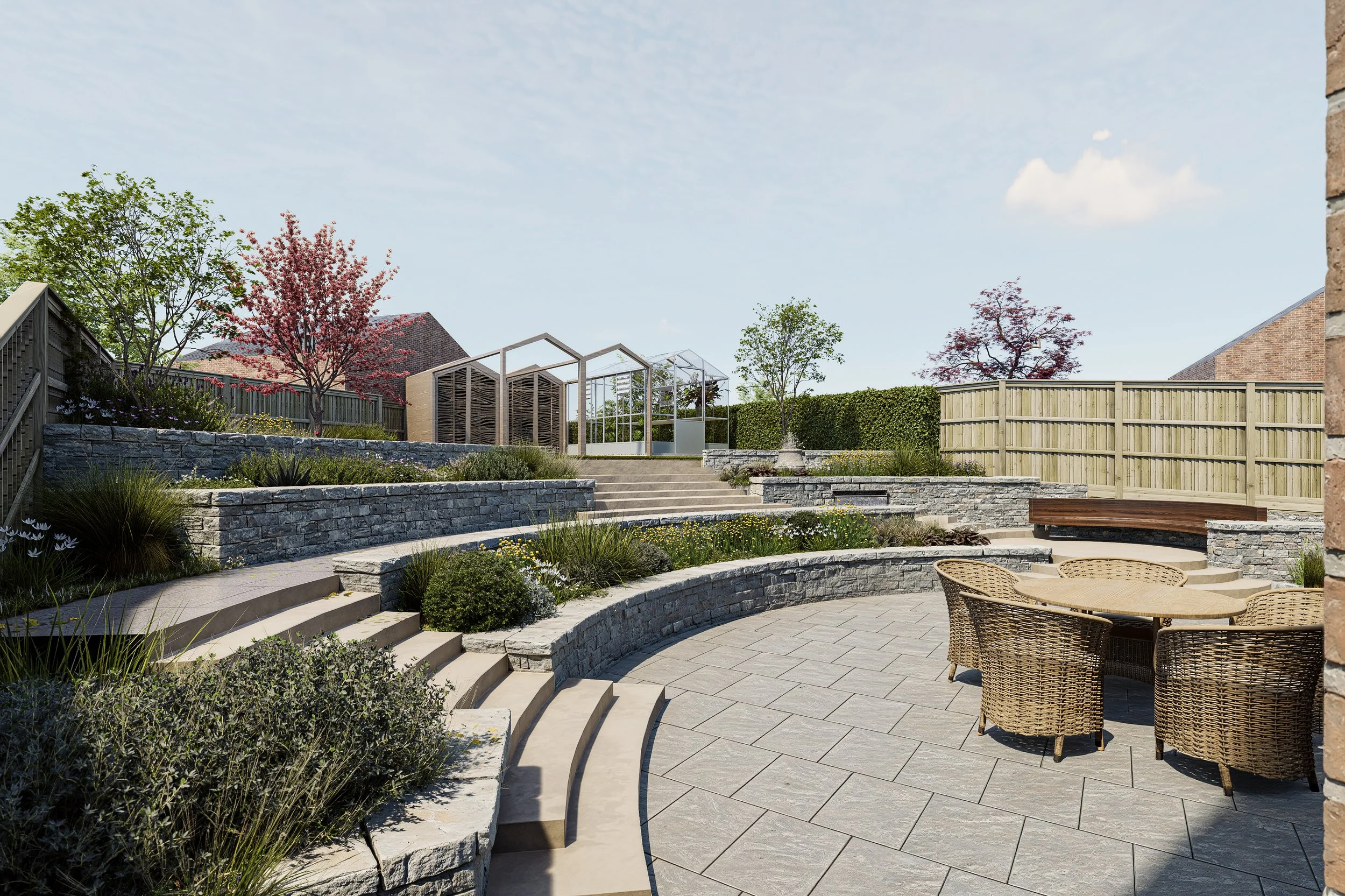 A landscaped backyard patio with stone steps, a curved stone wall, a round outdoor table with four wicker chairs, and a garden shed, surrounded by trees and a wooden fence.