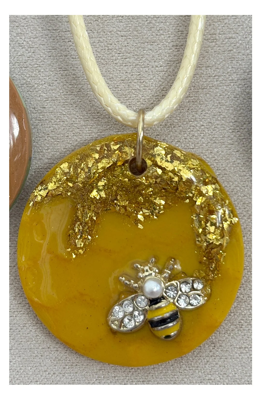 Gold Bee round pendant