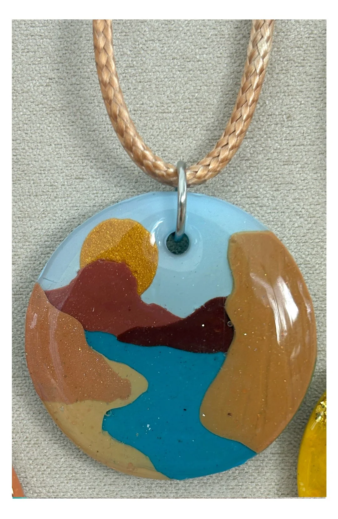Blue river with gold sun pendant