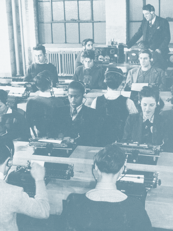 A vintage classroom scene with students using typewriters, a teacher at a radio console, and large windows in the background.