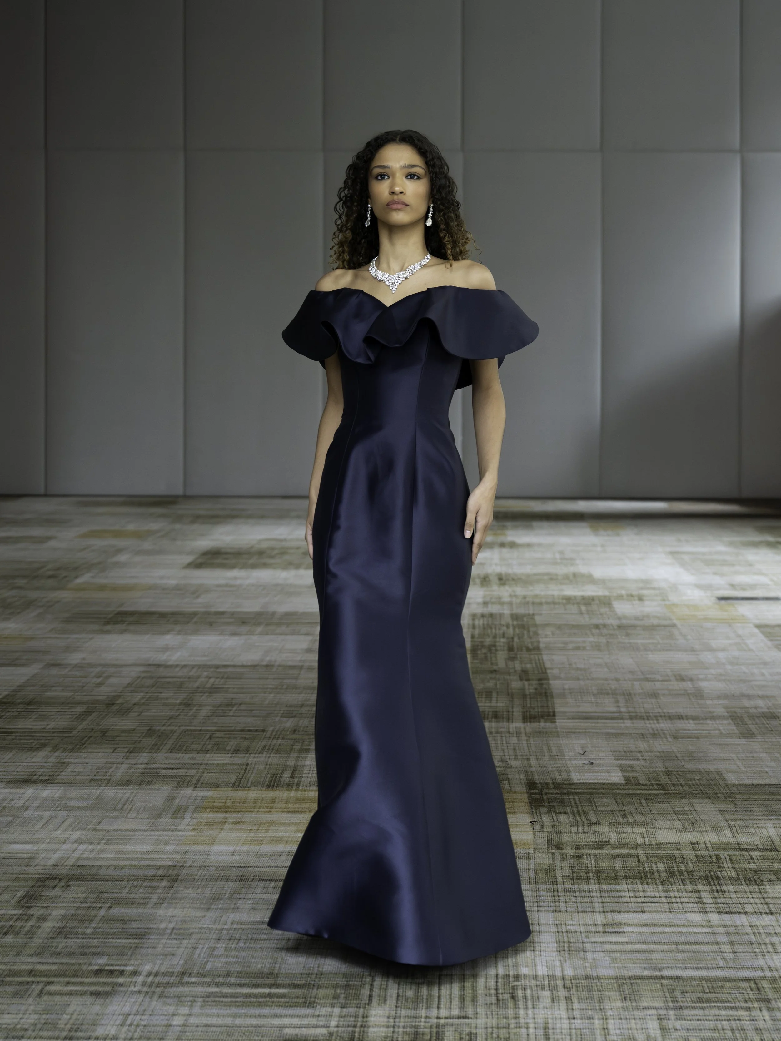 Model in structured navy gown walking during Veejay Floresca NYFW FW26 presentation produced by 3rd Space Productions
