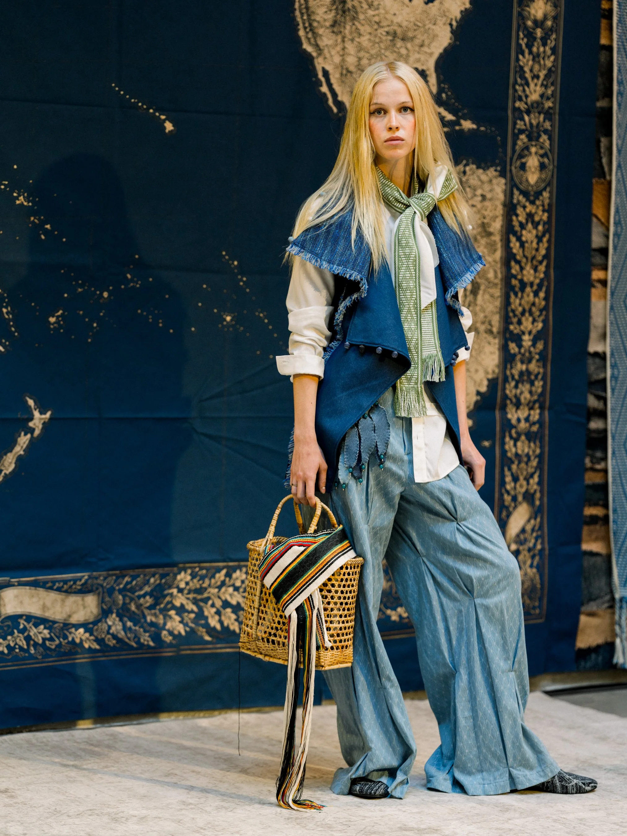 Model positioned within a Story Wear SS27 vignette during the brand’s NYFW presentation at Ideal Glass Studios.