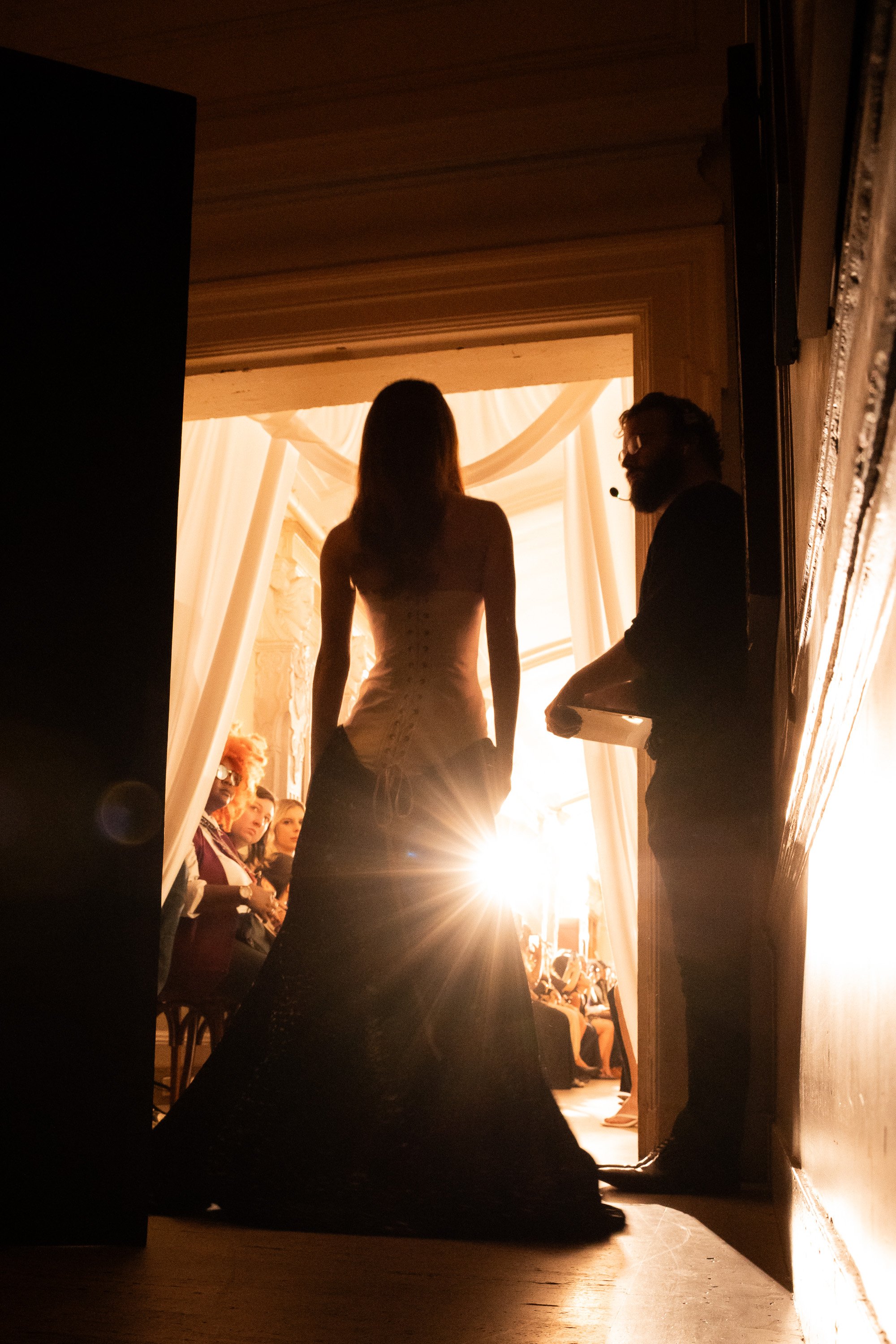Model waits backstage for her runway cue during Tang Chi Couture’s NYFW SS27 show at Freehand New York.
