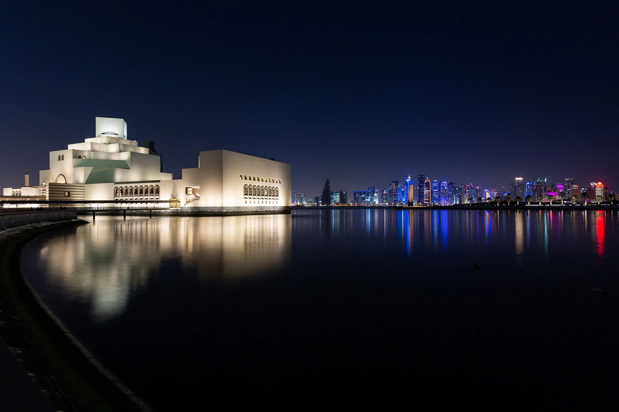 Night view of a Museum of Islamic Art, with Doha skyline. Photography by Talha Belal.