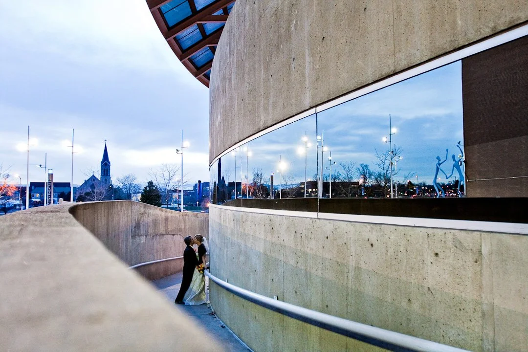 Bride and groom kissing in urban environemnt