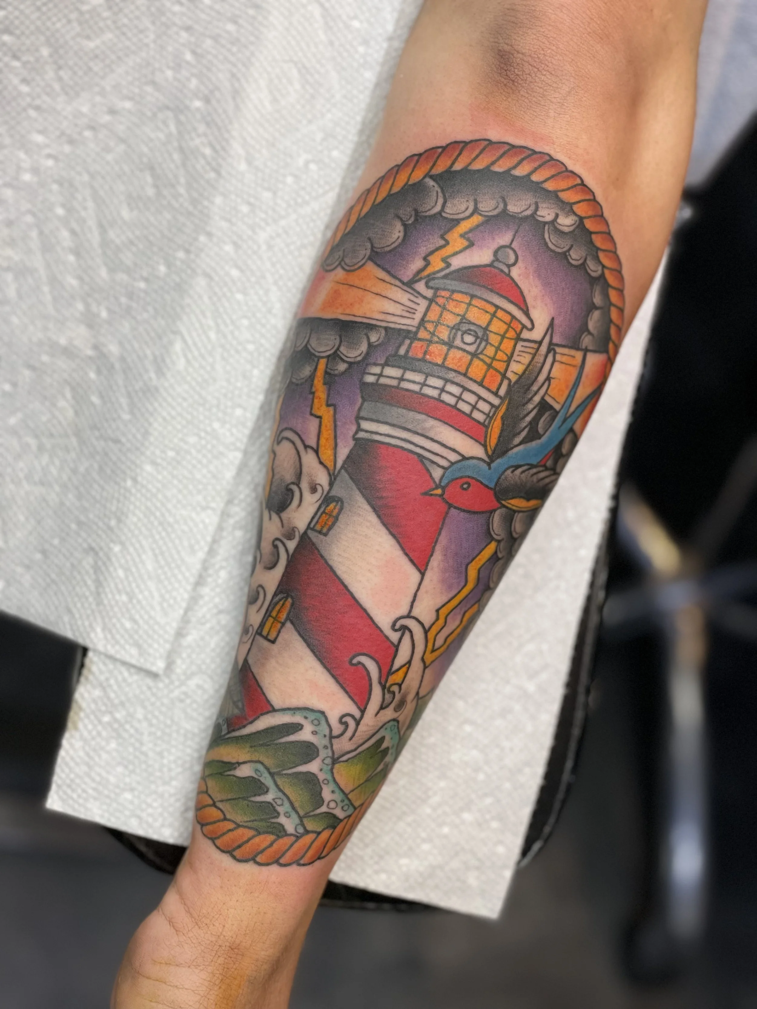 jake_traditional_lighthouse_tattoo.jpeg