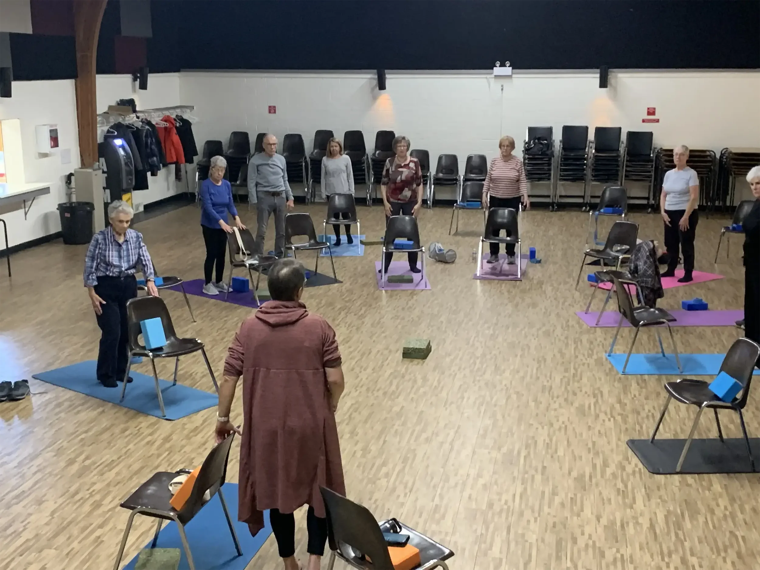 Seniors doing some chair yoga.
