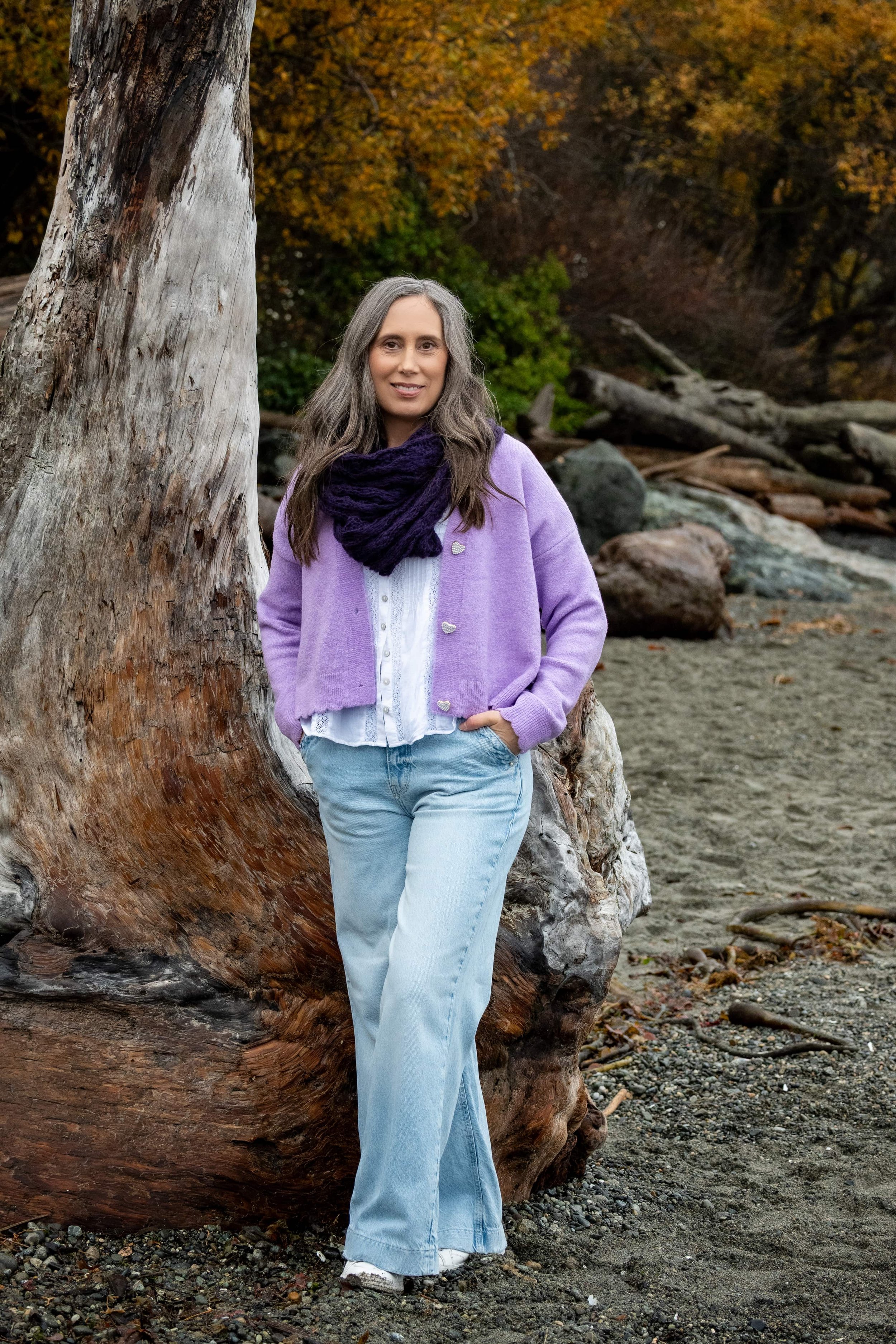Somatic trauma therapist and registered therapeutic counsellor Cynthia Solylo-Kennedy portrait photo on beach.