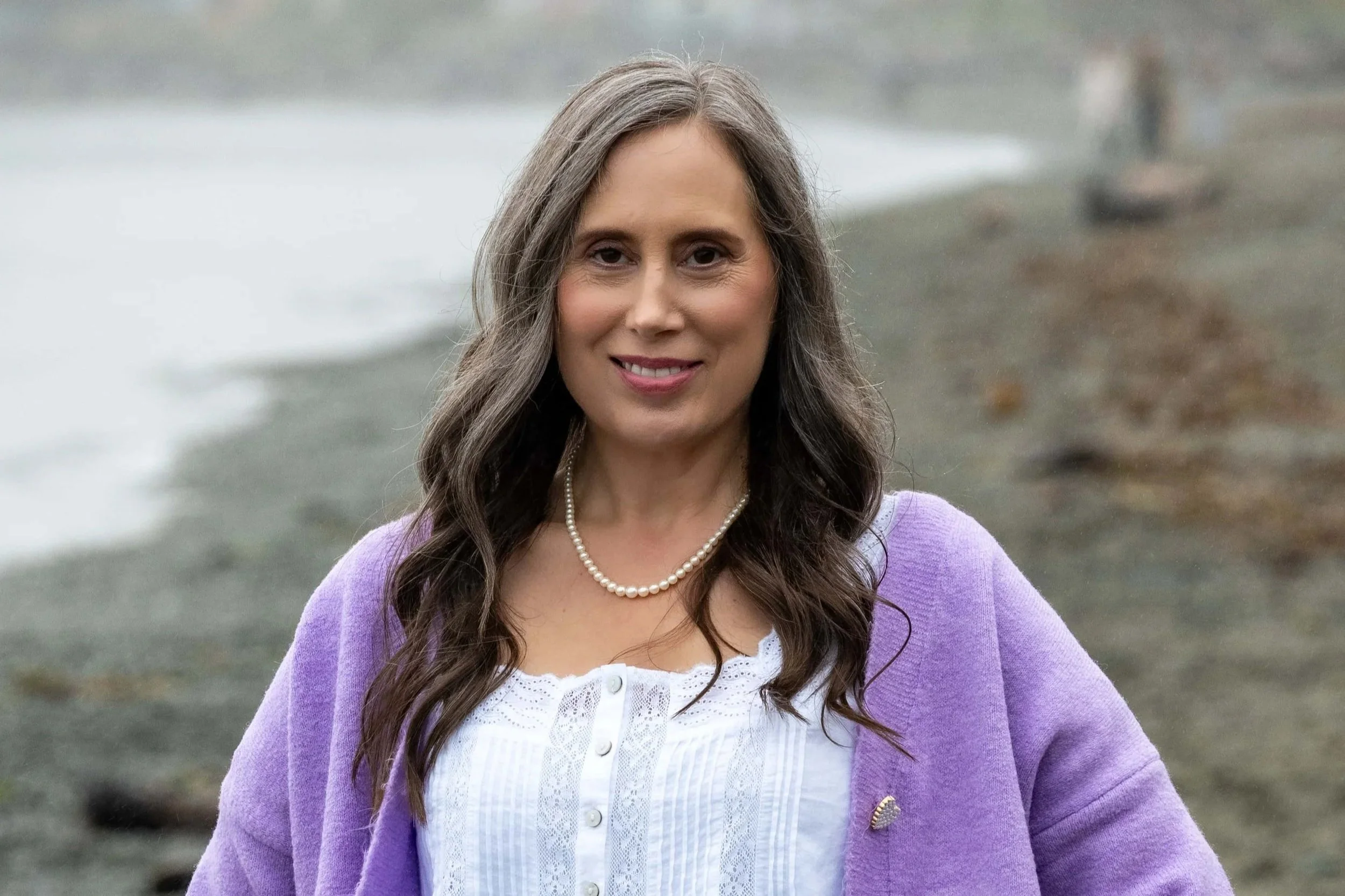 Cynthia Solylo-Kennedy standing on the beach, Somatic Experiencing practitioner and RTC registered therapeutic counsellor in Victoria BC Canada.