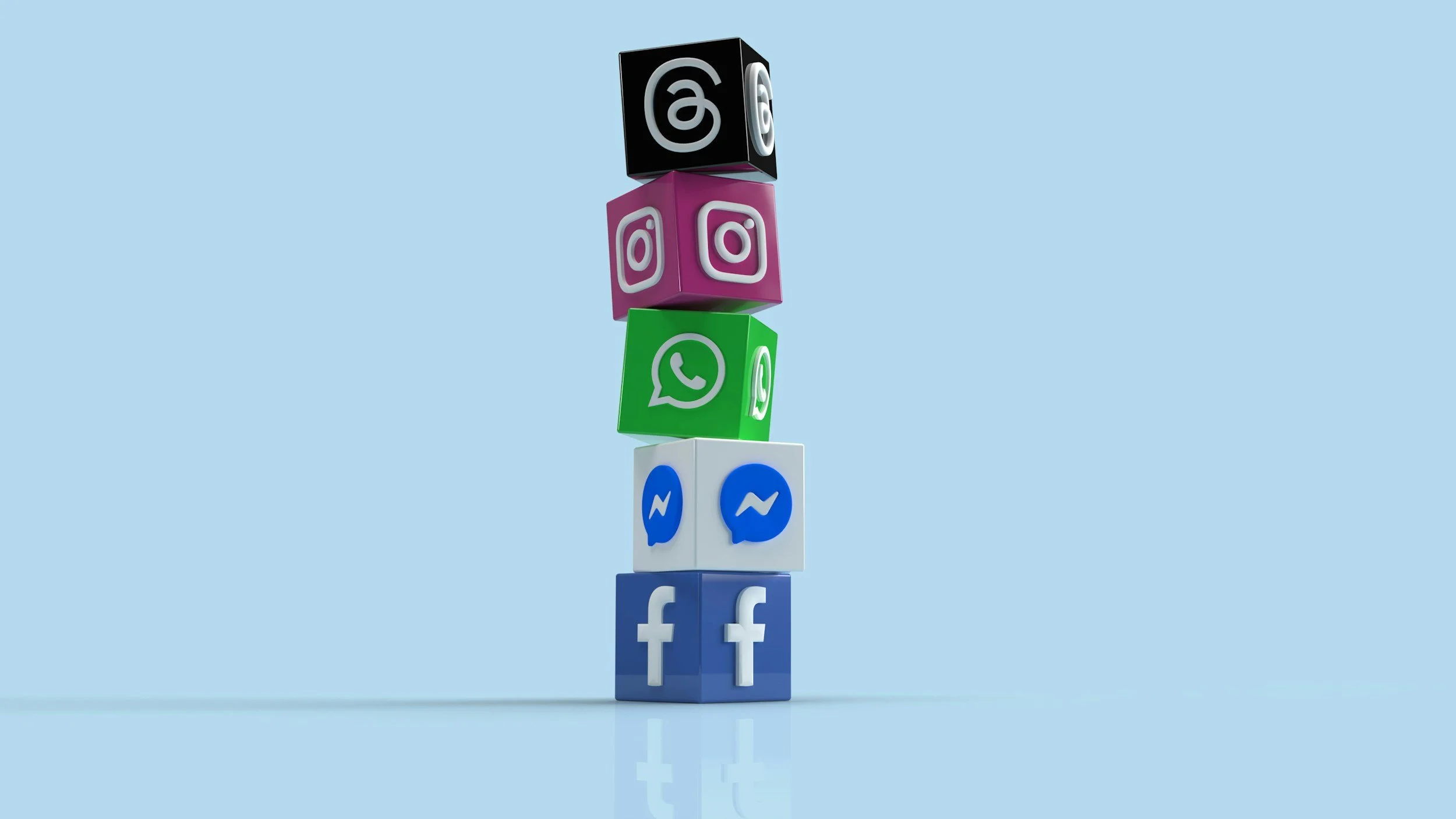 Stacked colorful cubes with social media icons on a light blue background, arranged vertically.
