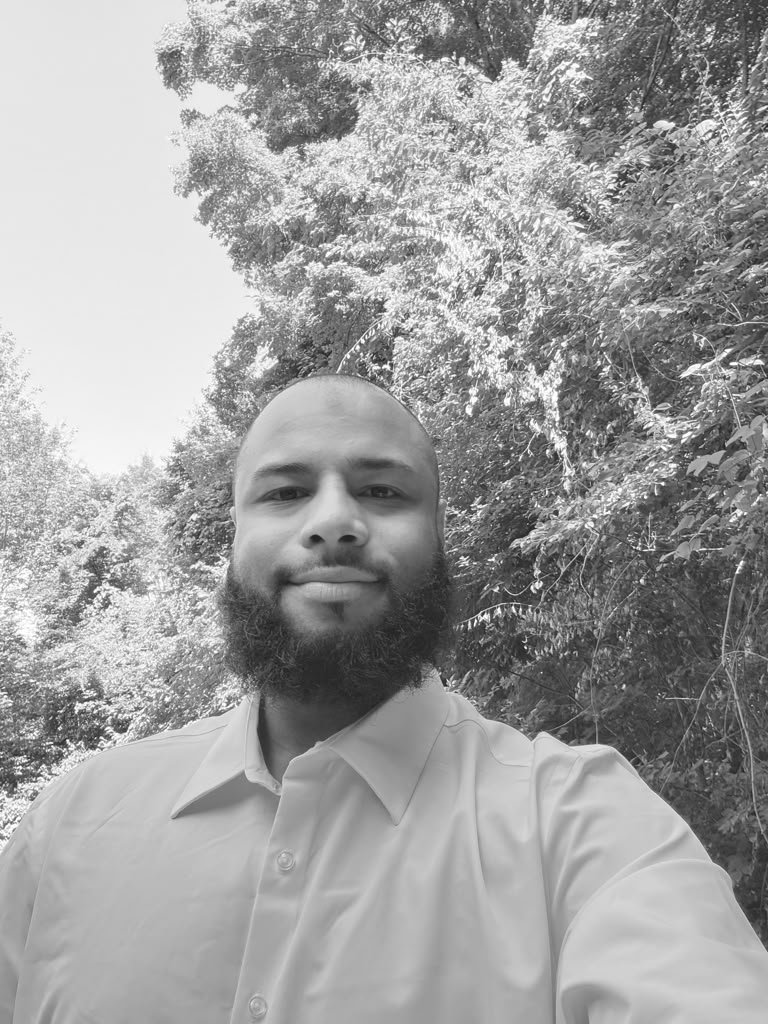Joseph, founder of FlowStateDevCo, smiling outdoors in a light shirt
