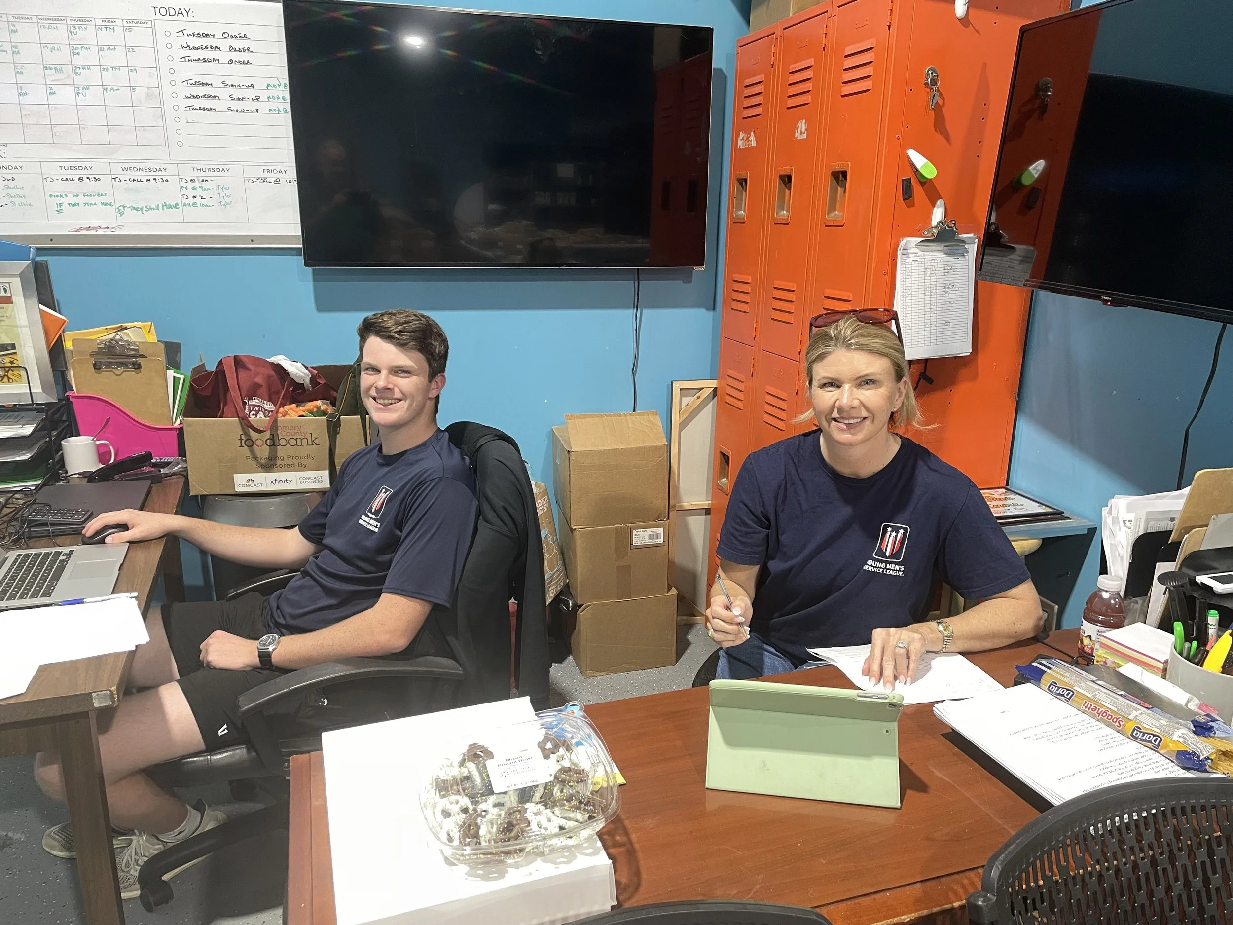 Volunteers Sitting on a Desk
