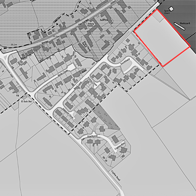 A grayscale map showing a residential area with streets, houses, and a highlighted plot outlined in red in the northeastern part of the map, near a railway line.