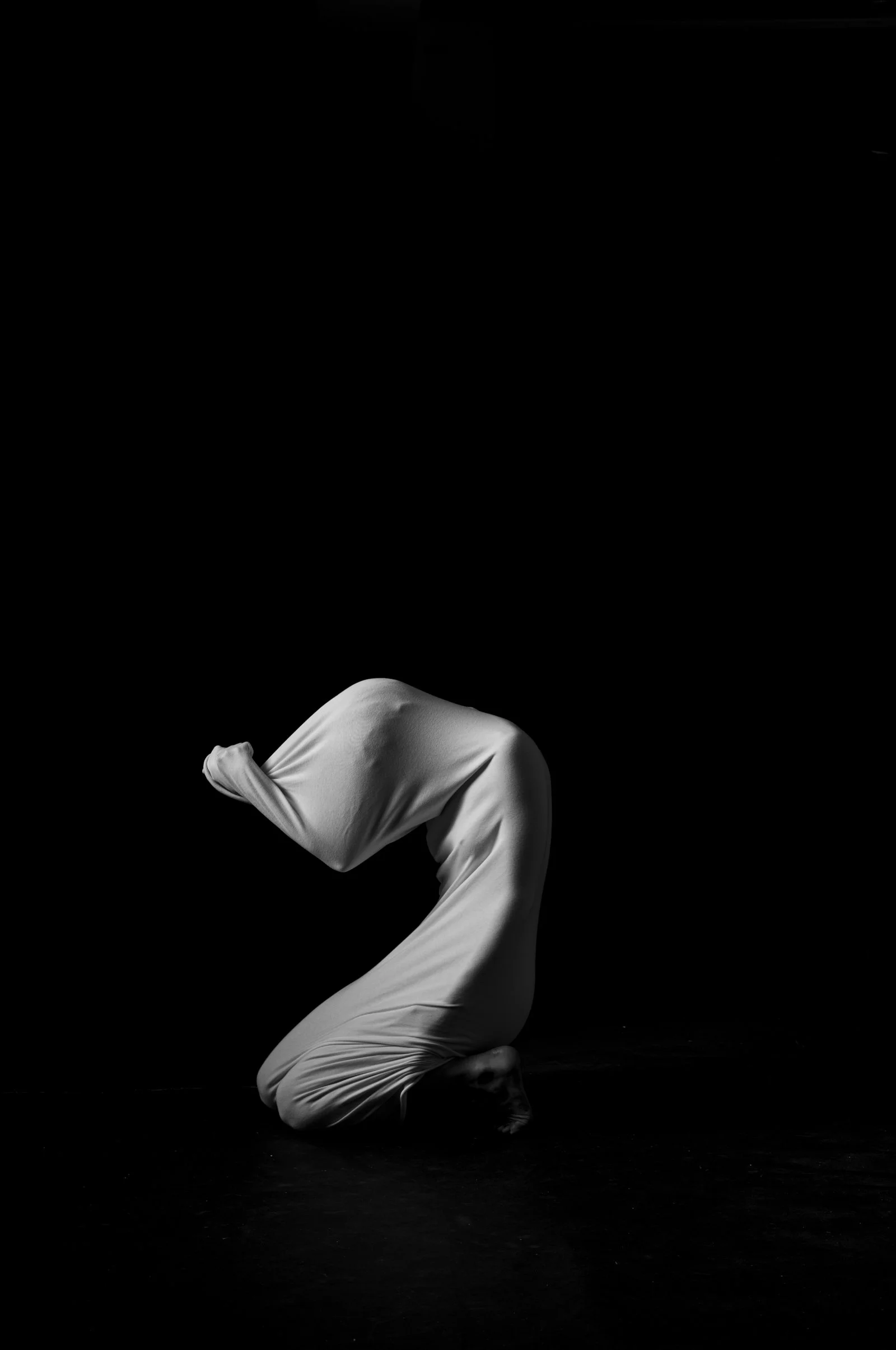 Minimalist study of body contours and light, emphasizing the sculptural essence of the form.