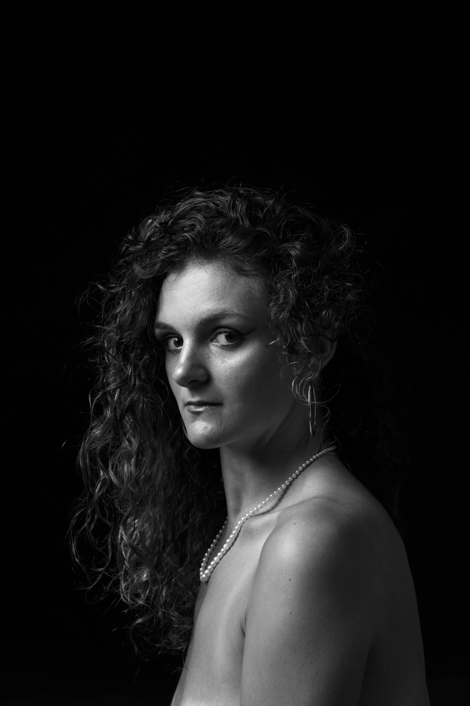 High-contrast artistic portrait study with a focus on simplicity, mood, and form.