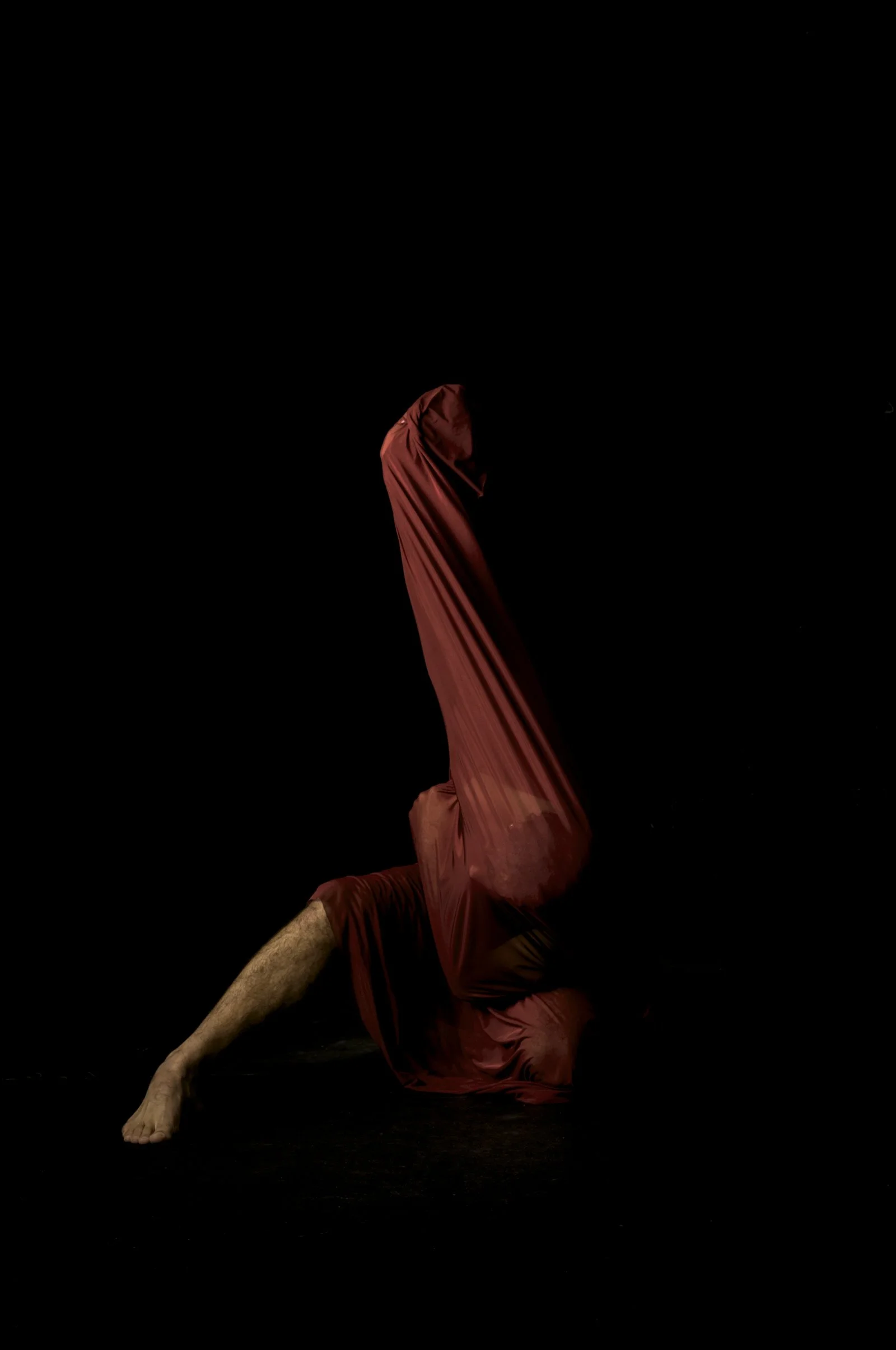 A dramatic pose in the chiaroscuro style, person emerging from a black background.