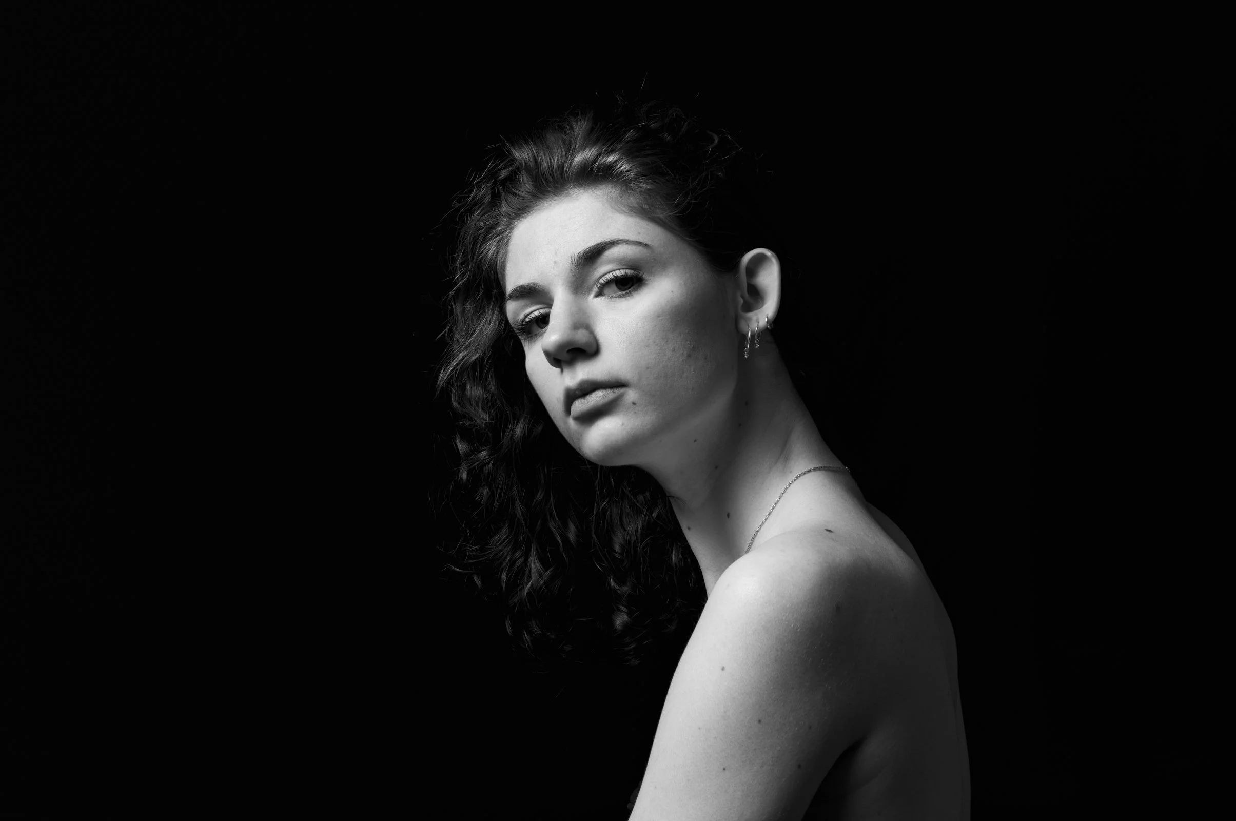 Moody and minimalist portrait study, using light to create depth and quiet intensity.