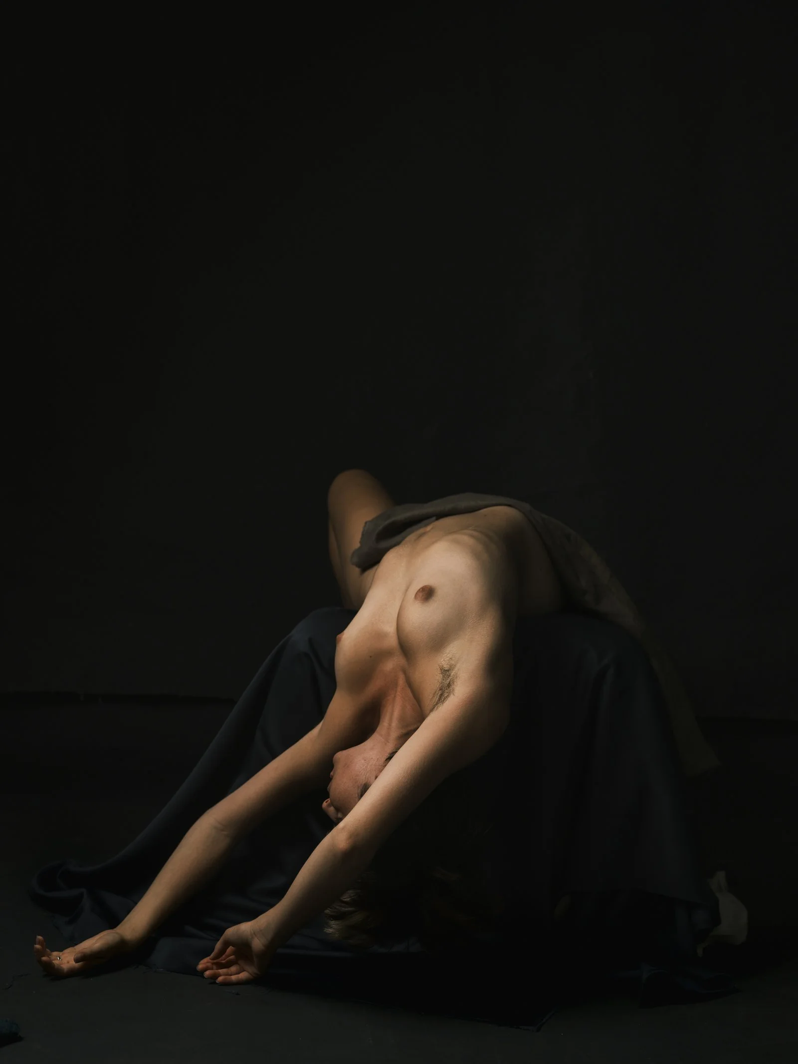 Low-key portrait using Rembrandt lighting to create a triangular highlight on the subject's cheek.