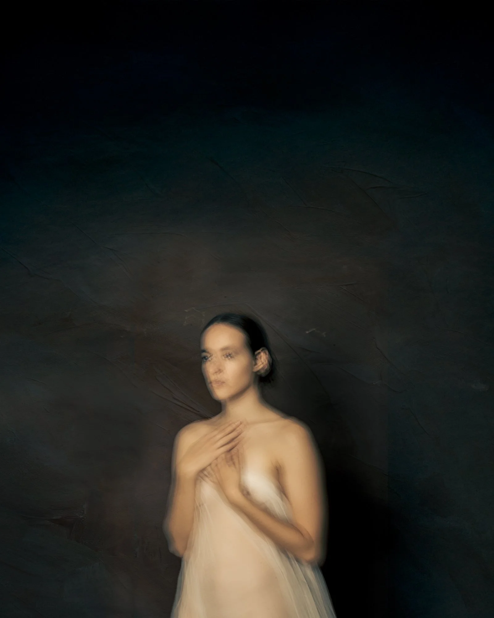 Ethereal fine art portrait showing graceful movement and blurred contours in a painterly style.