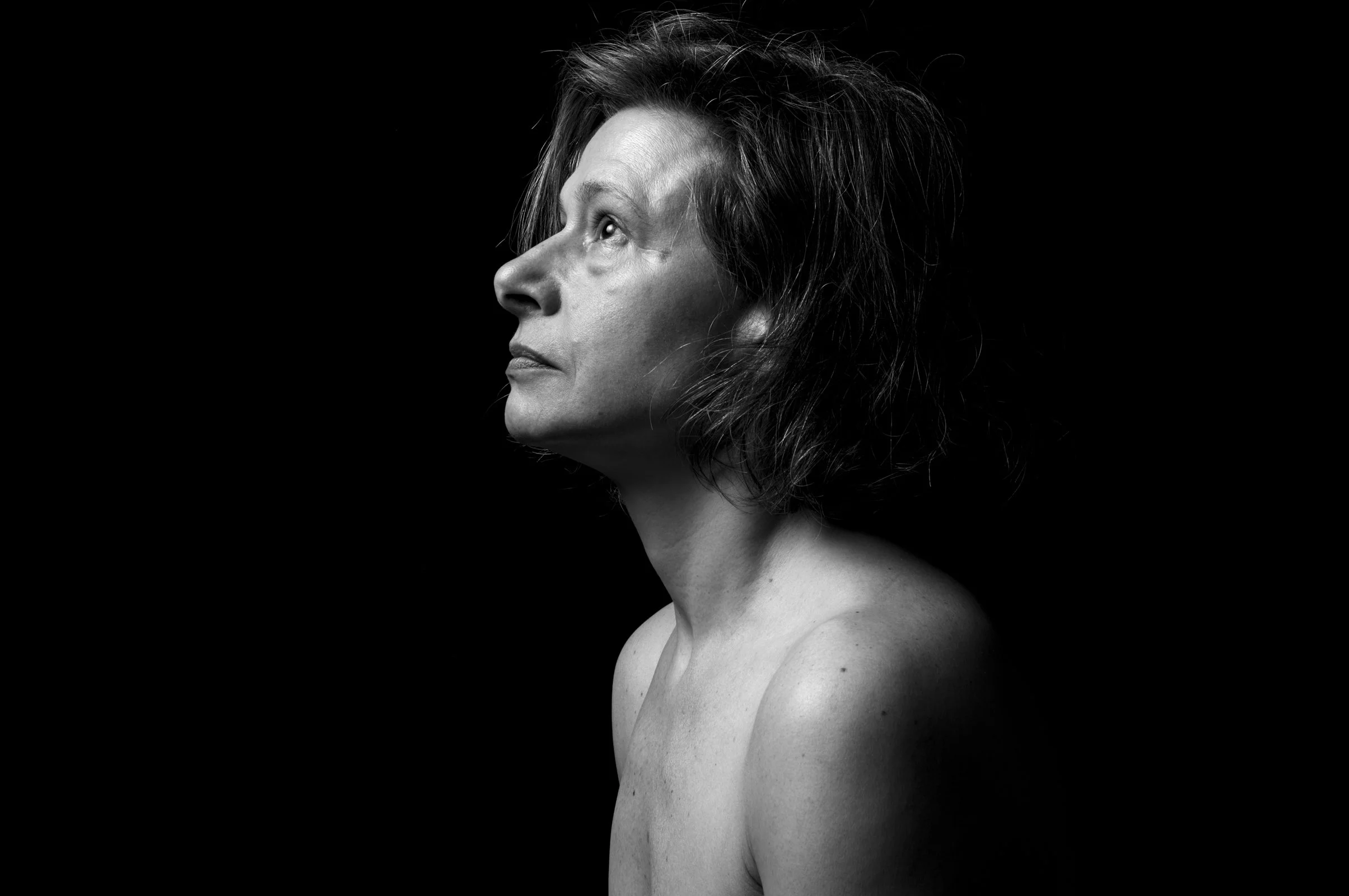 Renaissance-inspired photography study of a person in a minimalist, high-contrast pose.