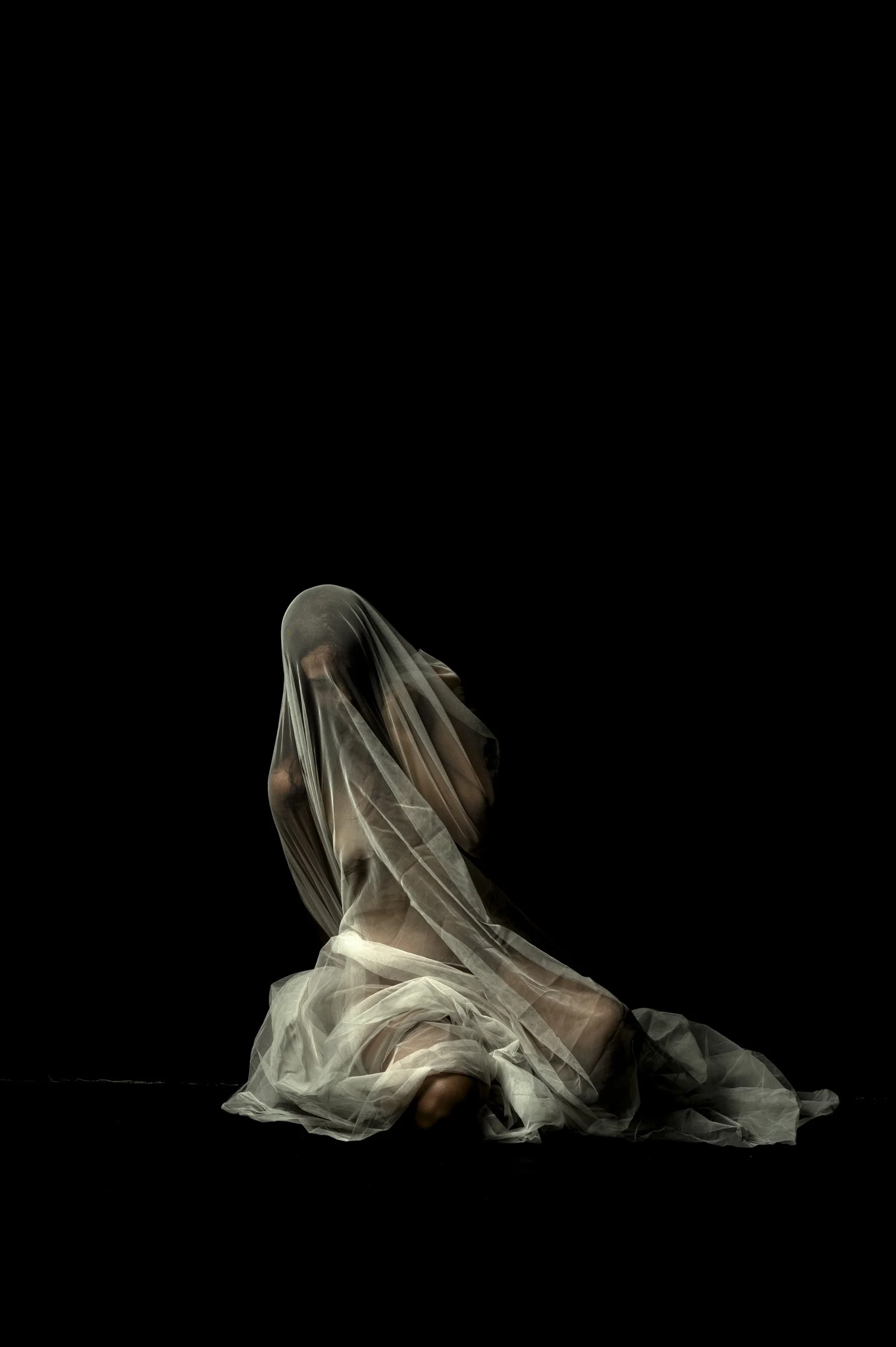 A person in a dynamic crouching pose under a red veil, Tension series by SJ Fine Art.