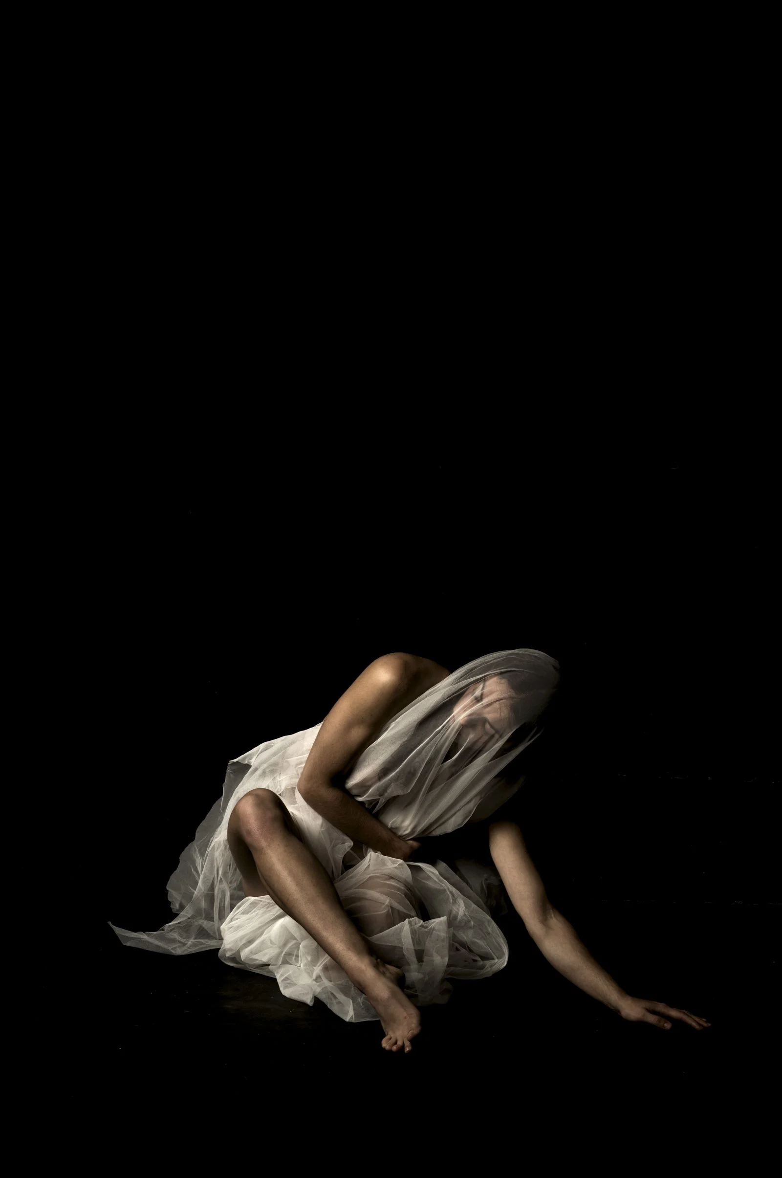 Fine art chiaroscuro portrait from the Tension series, showing a figure emerging from deep shadow.