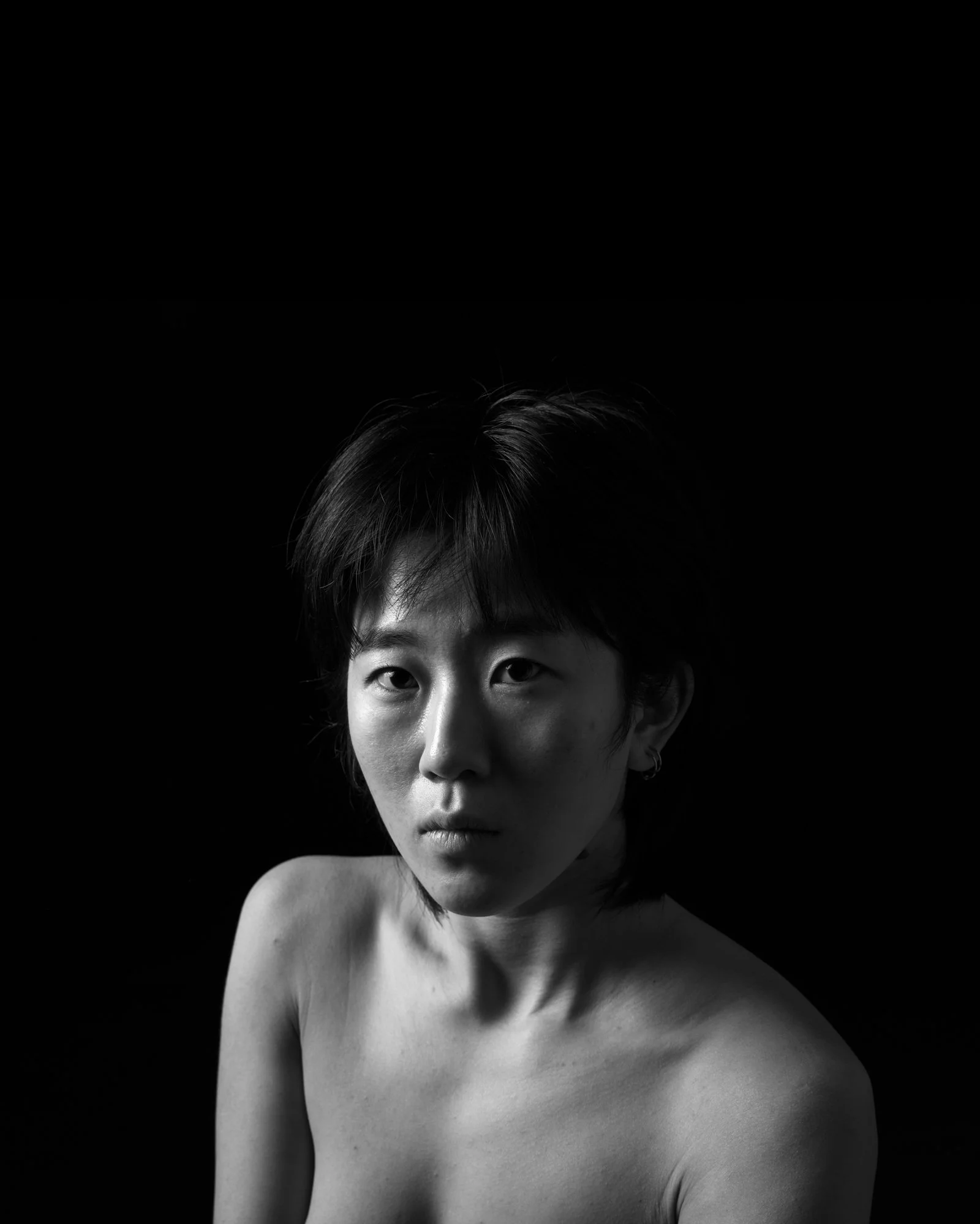 Painterly profile focusing on the bridge of the nose and forehead in soft light.