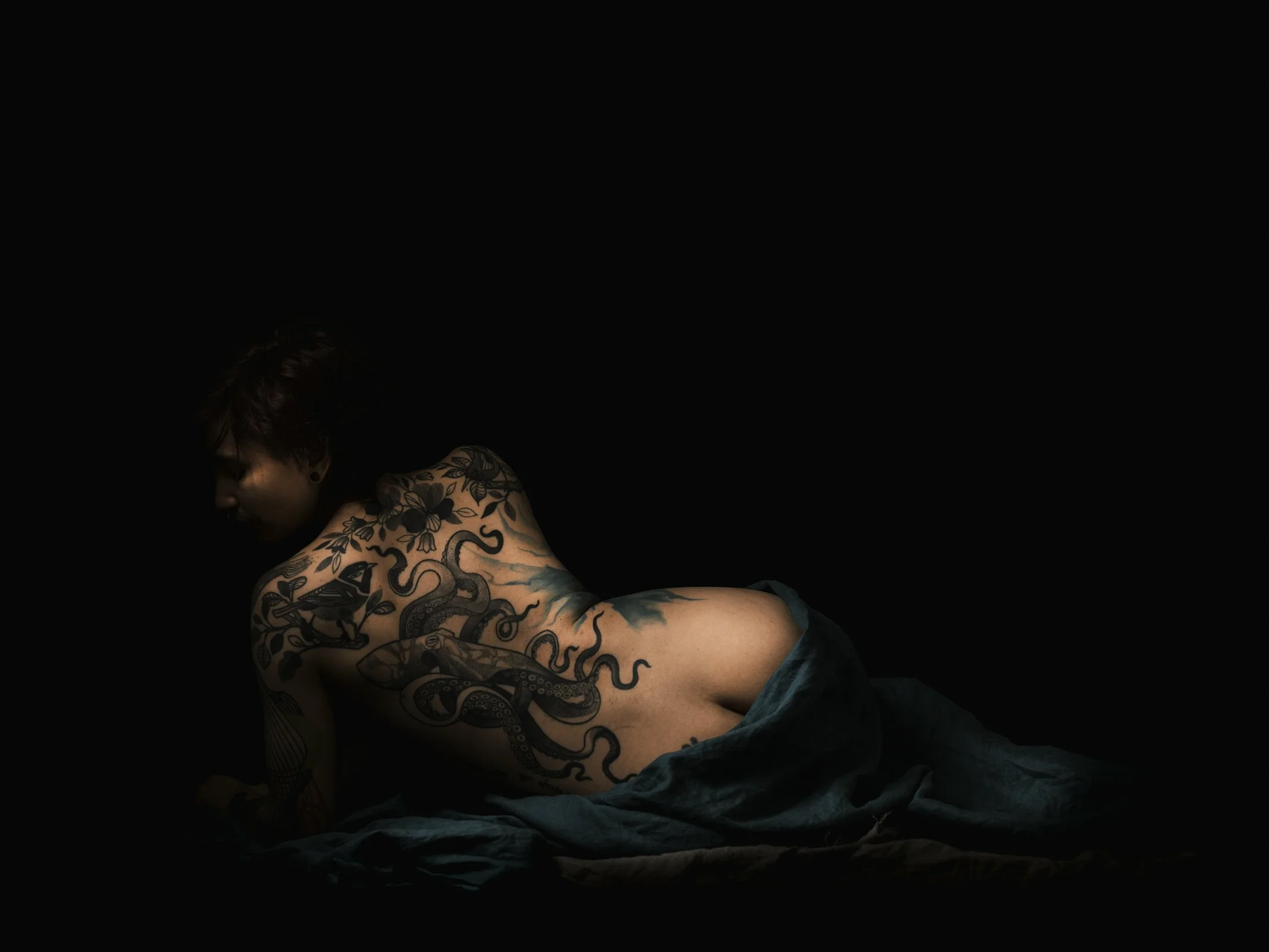 A master study in light modeling, featuring a three-quarter portrait with deep, atmospheric shadows.