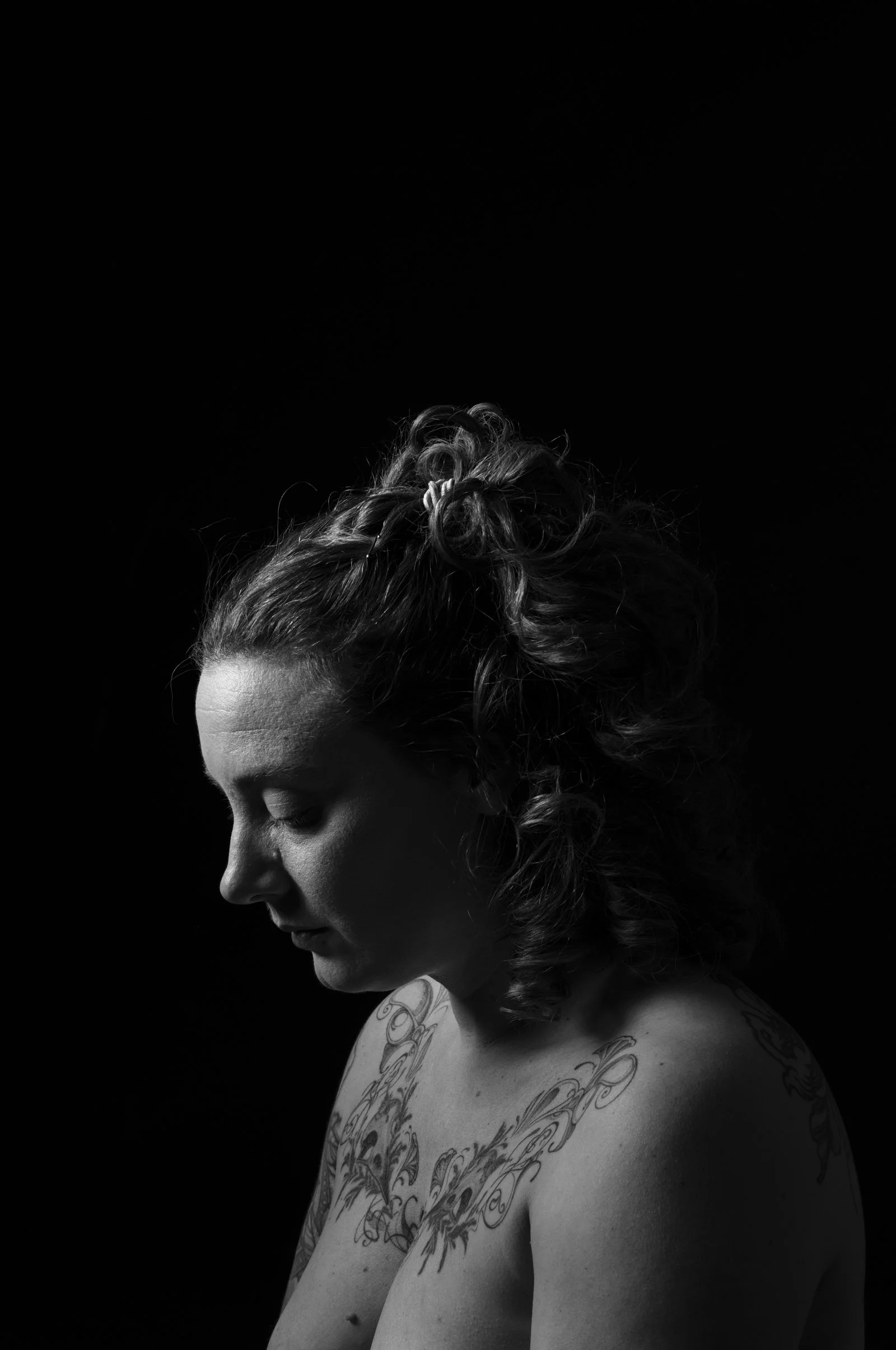 Fine art print showing the sculptural qualities of the human form under direct light.