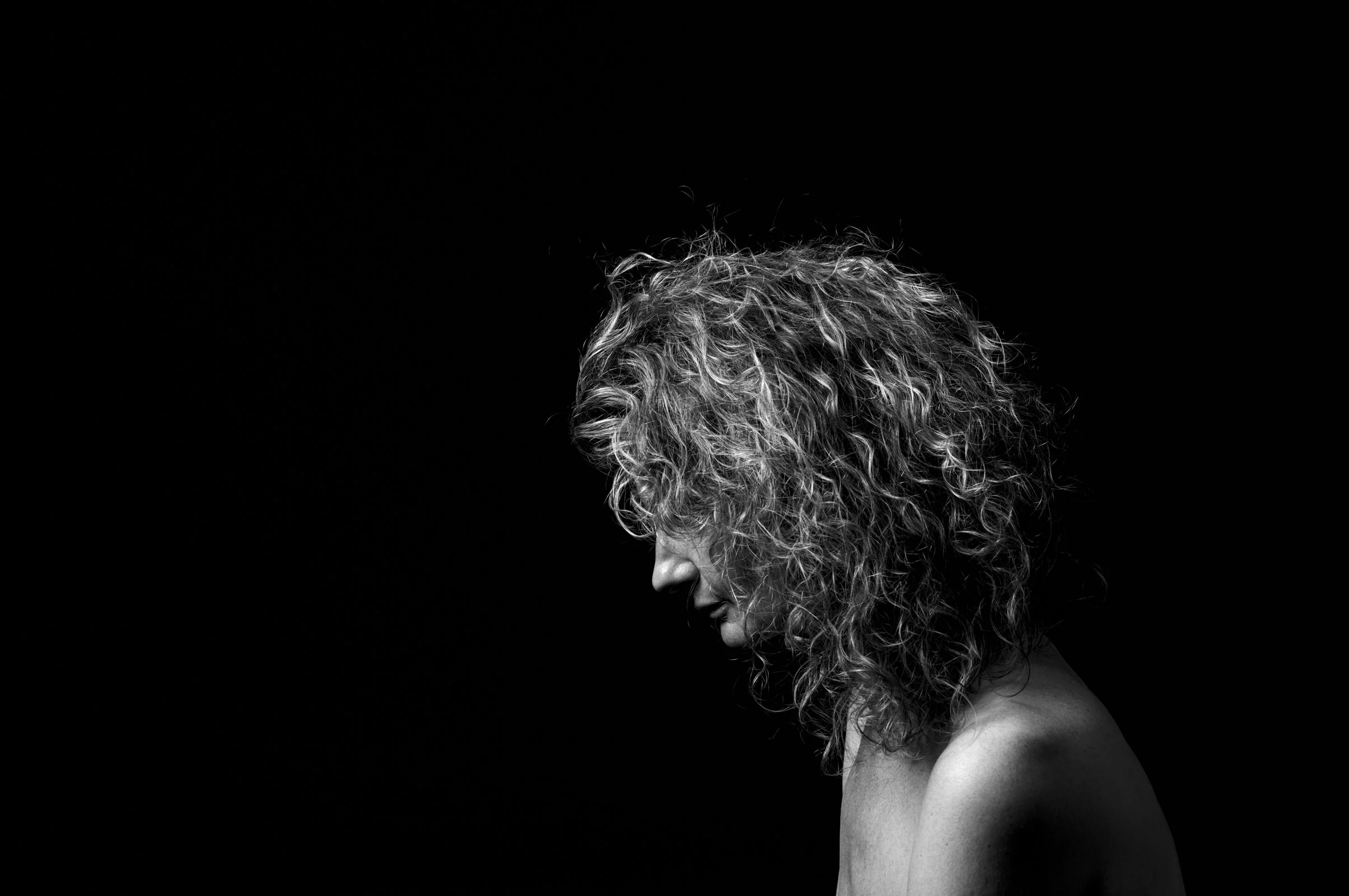 Moody, minimalist portrait captured in the chiaroscuro tradition of the old masters.