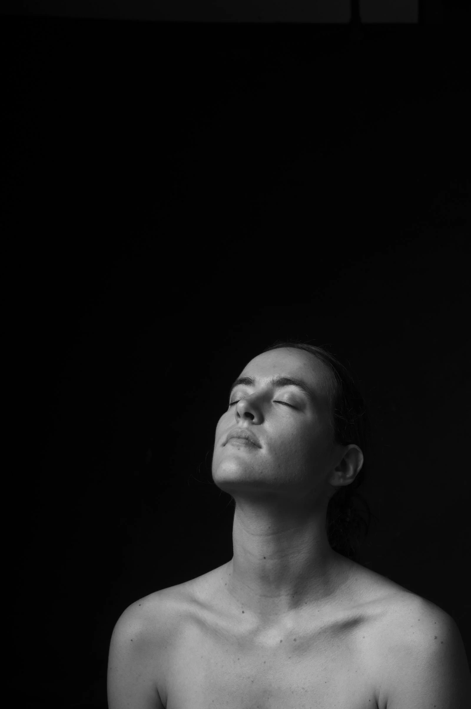 Shadow-focused portraiture from the People series, exploring form and mystery.