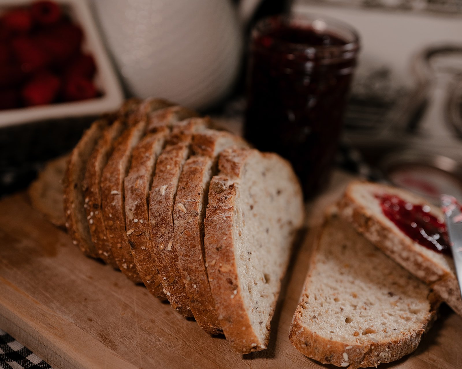 Do you need to go gluten-free for PCOS? Bread and jam with knife sitting on kitchen countertop
