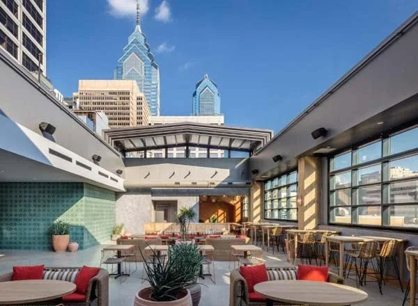 Rooftop bar in Philadelphia with outdoor seating and view of the Liberty Place skyscrapers.