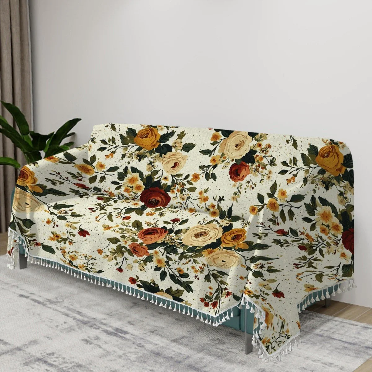 Living room with a floral-patterned sofa cover on a teal sofa, next to a potted plant, against a plain white wall.