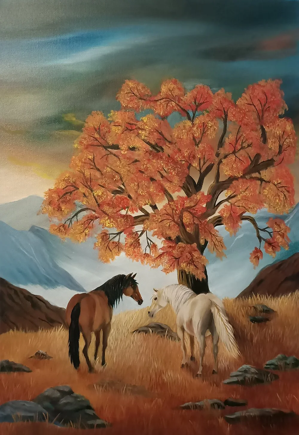 Painting of two horses standing in a field of golden grass with a large tree with orange autumn leaves, mountains in the background, and a cloudy sky.