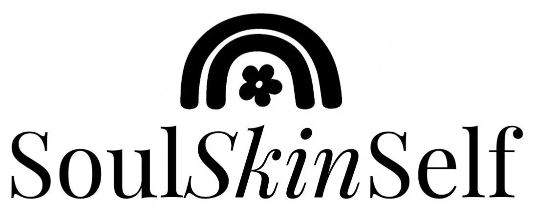 Logo for SoulSkinSelf with a black and white rainbow and flower
