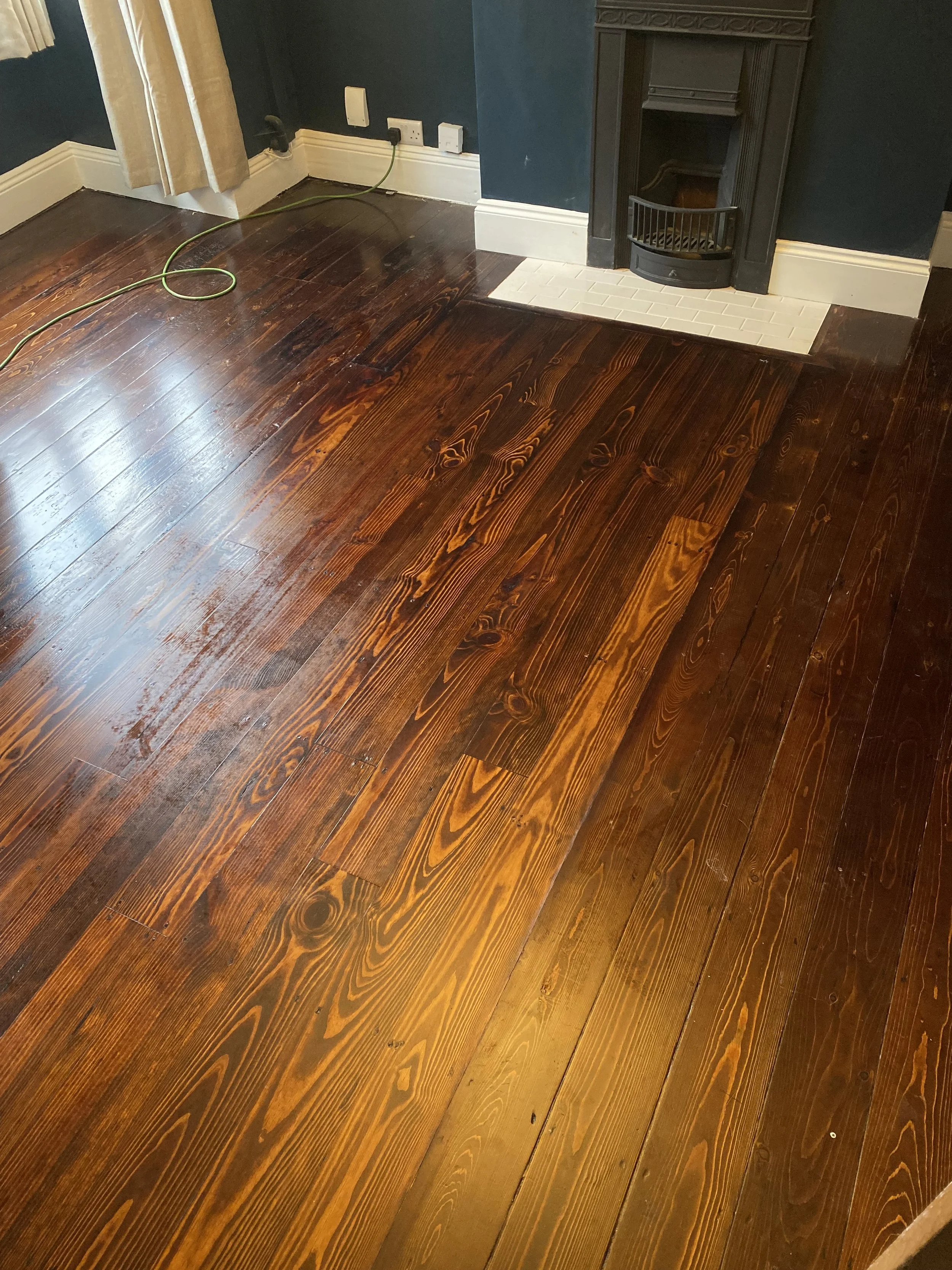 Repaired pine floorboards sanded, filled, and stained to blend with the surrounding floor in Bournville Birmingham