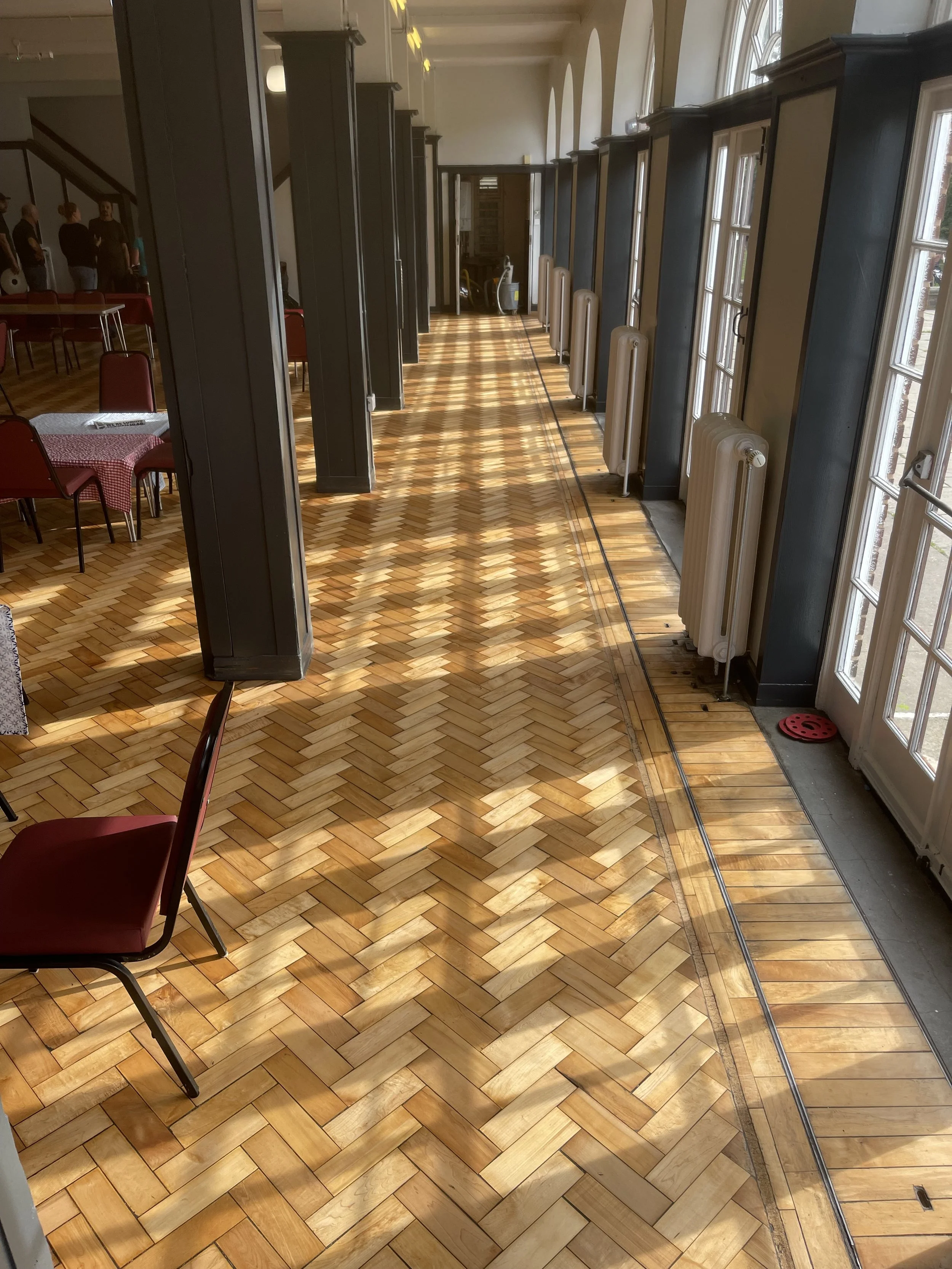 Beech parquet herringbone floor after sanding and restoration in Pavilion Hall, Bournville, Birmingham