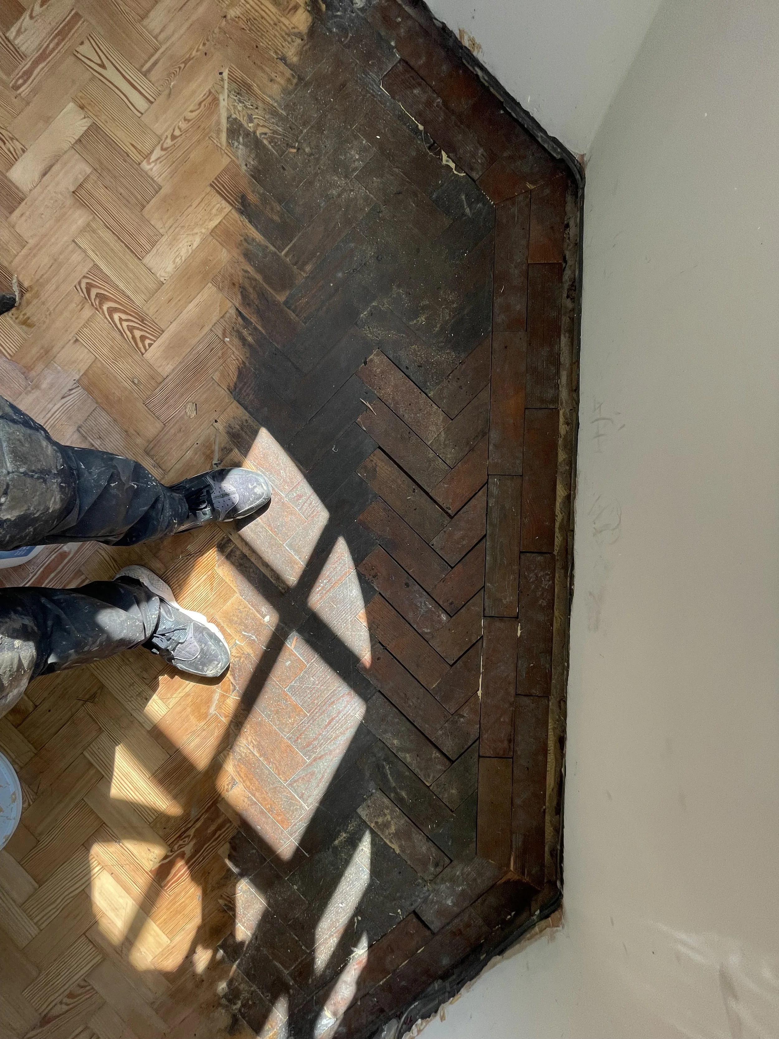 Pine herringbone parquet floor during repair, with gaps visible before sanding and finishing, Harborne Birmingham