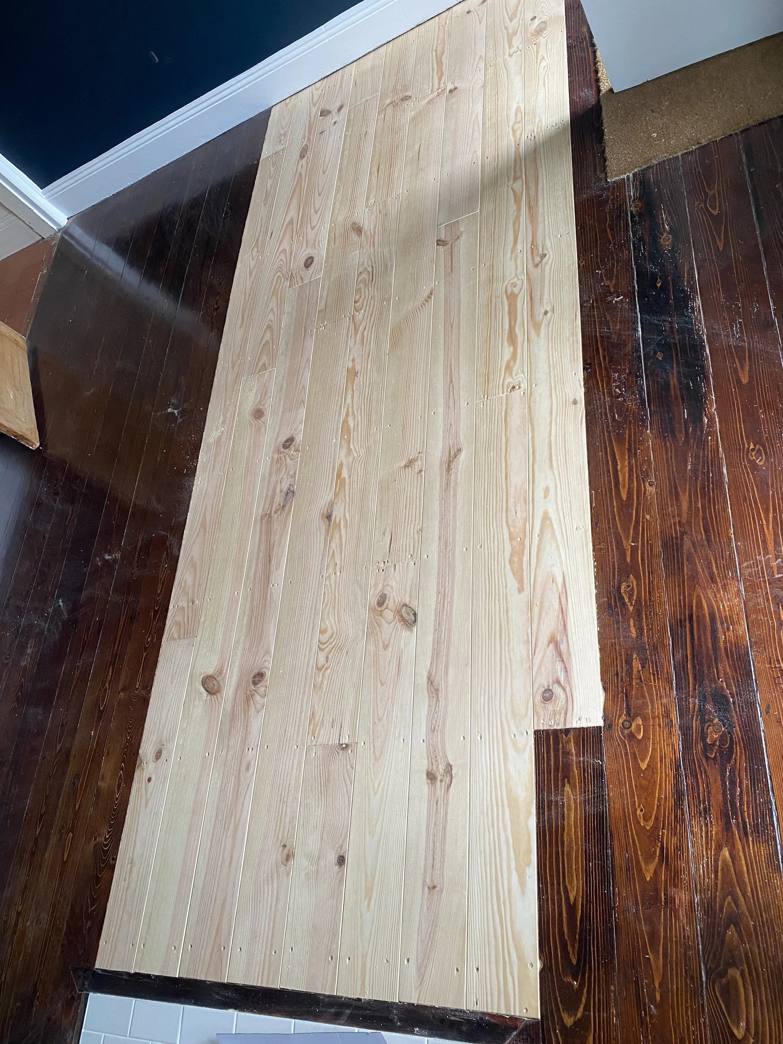 Newly fitted pine floorboards installed as part of a repair, prior to sanding or finishing in Bournville Birmingham