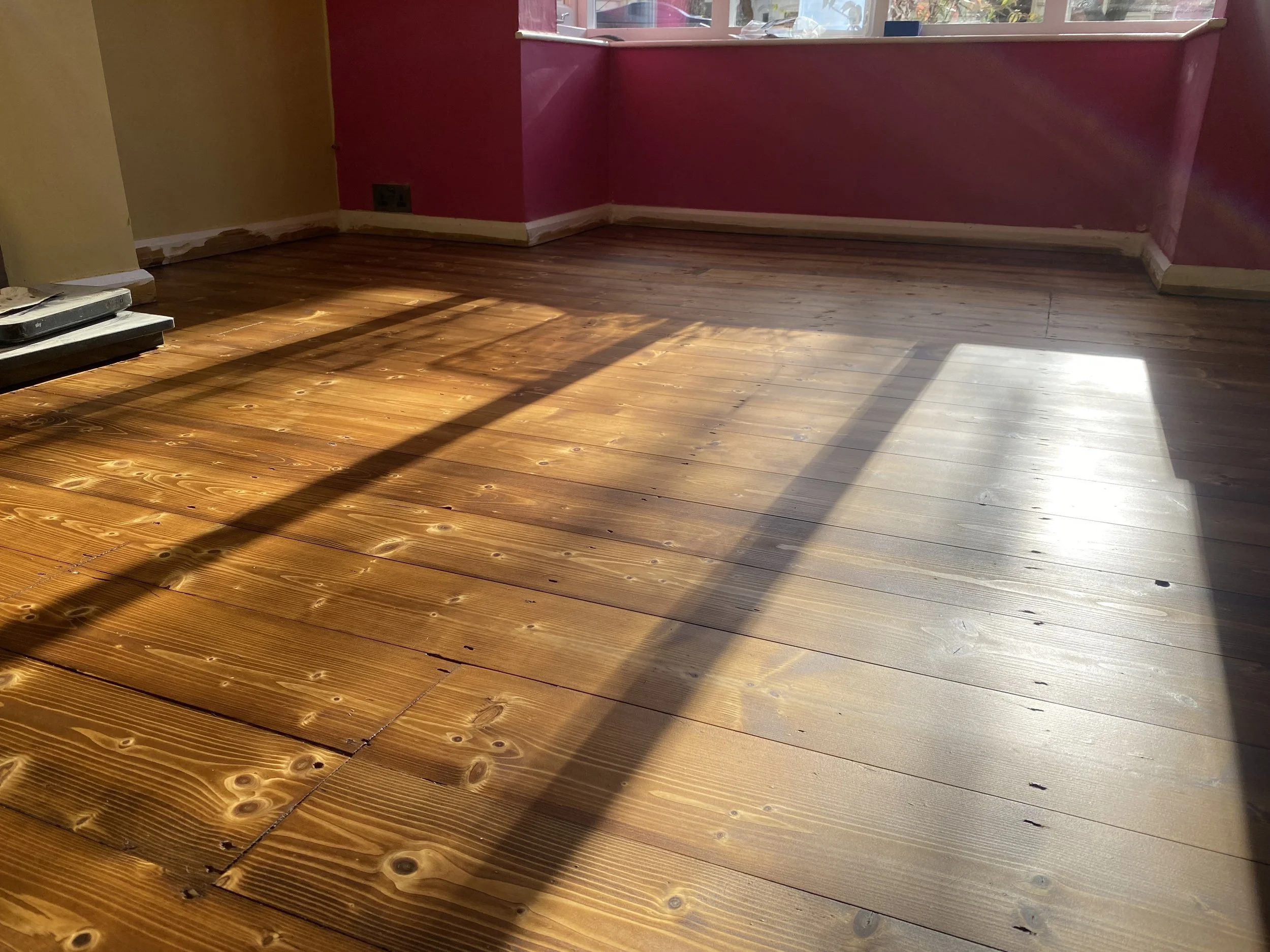 Pine floorboards in Selly Oak, Birmingham, sanded, filled, restored, and finished with a solvent based stain and lacquer