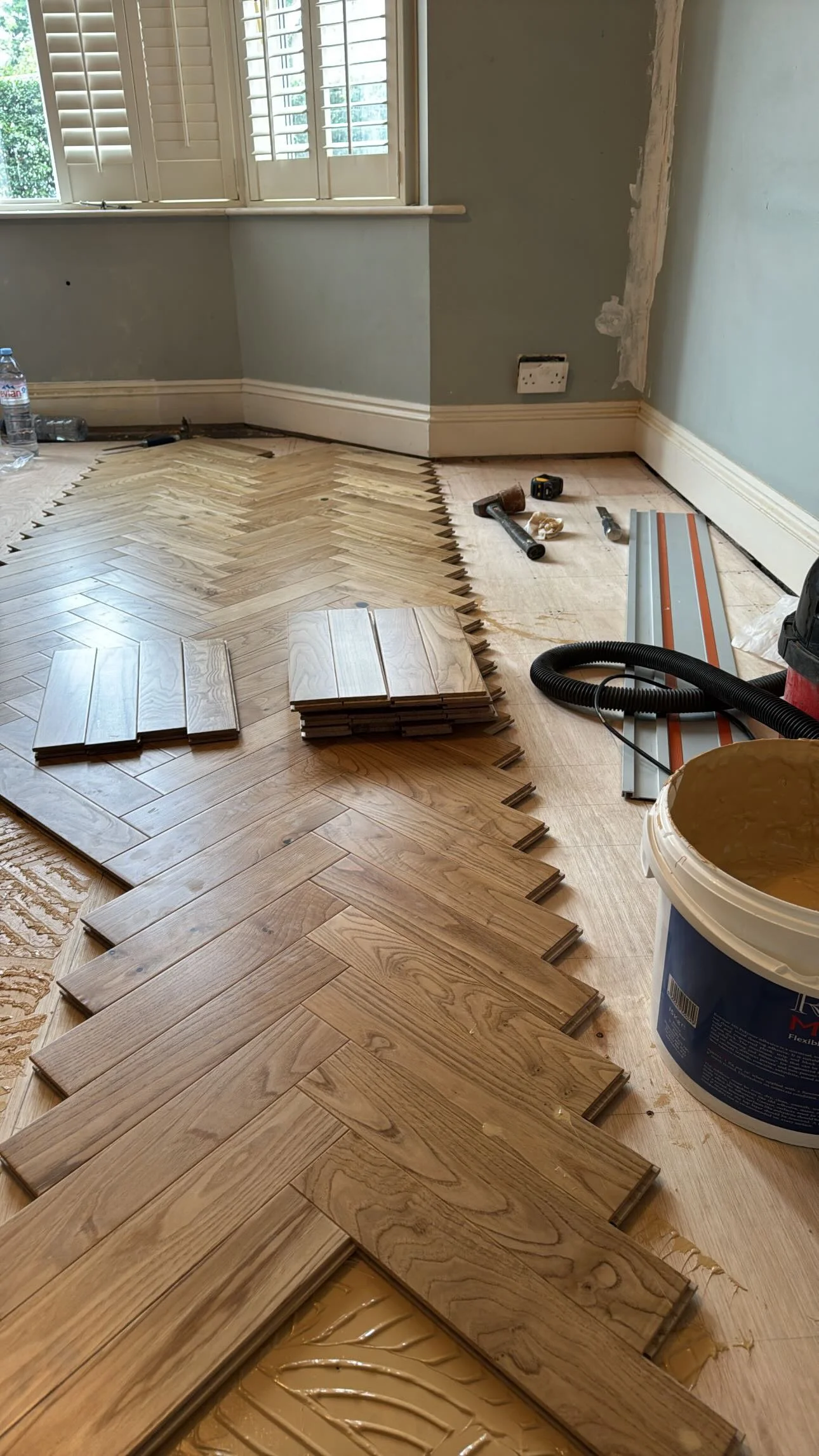Laying solid oak herringbone parquet flooring by hand in Coventry, West Midlands
