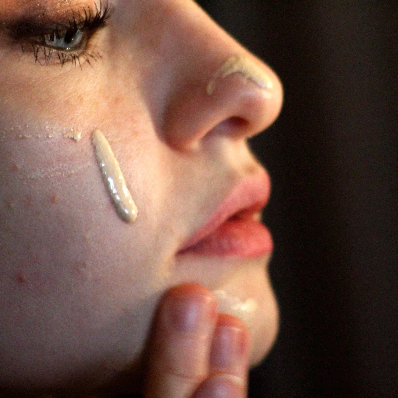 [Image of a woman's side profile with foundation dripping down her cheek]