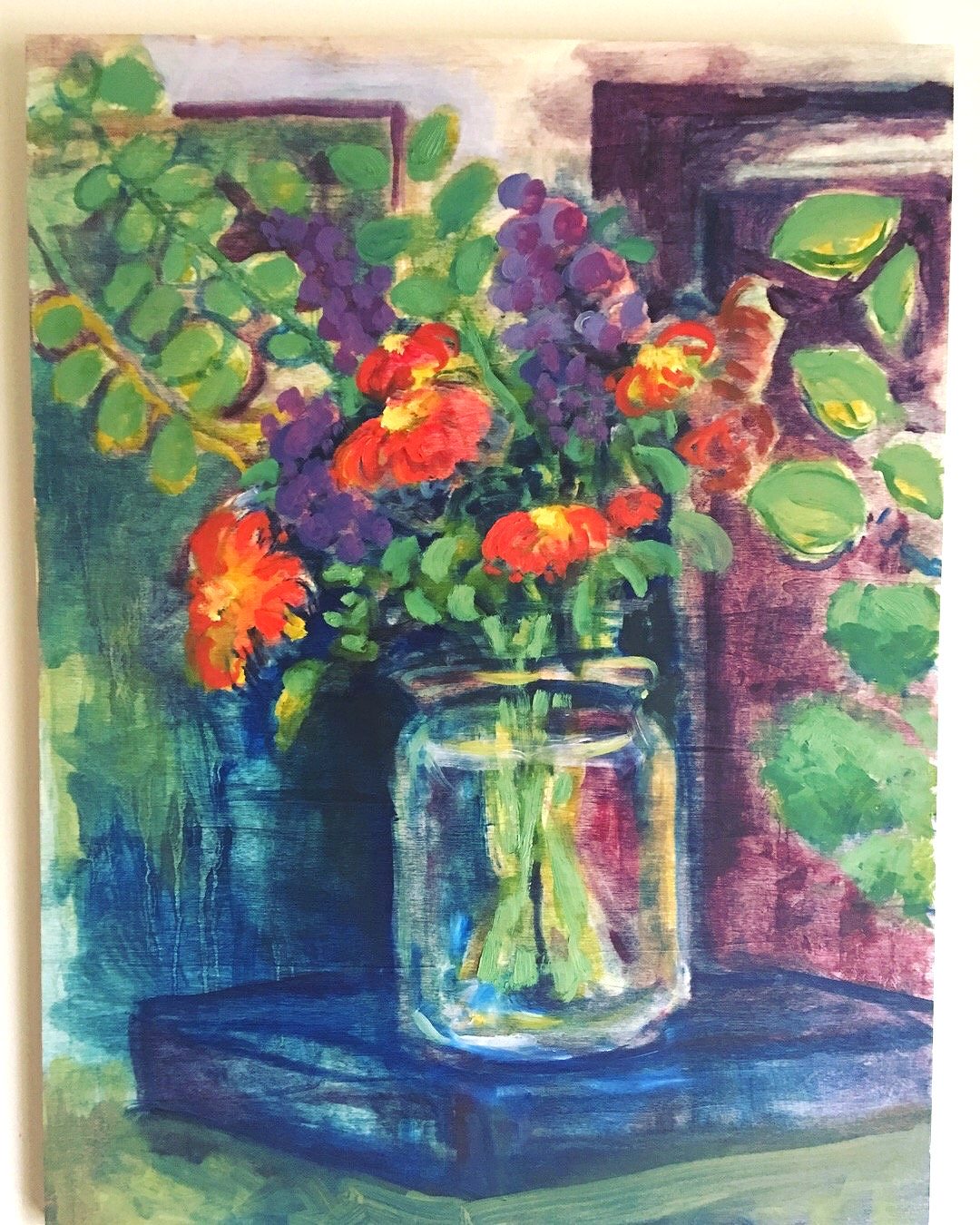 Painting of a colorful flower arrangement in a glass jar, placed on a dark blue table with a background of green and purple hues.