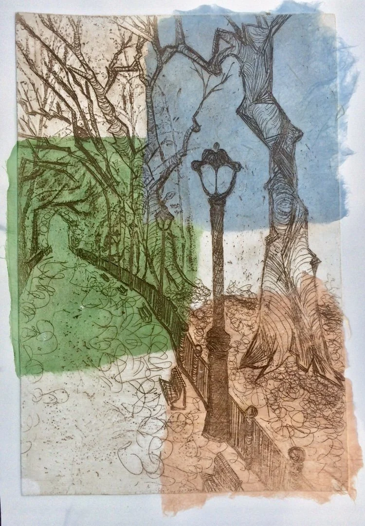 A unique mono print of a park scene with leafless trees, a pathway, a lamppost, and a fence, overlaid with handmade paper patches in blue, green, and peach.