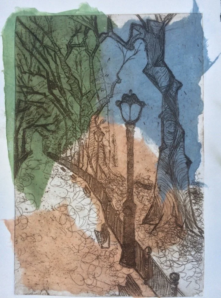 A unique mono print of a park scene with leafless trees, a pathway, a lamppost, and a fence, overlaid with handmade paper patches in blue, green, and peach.