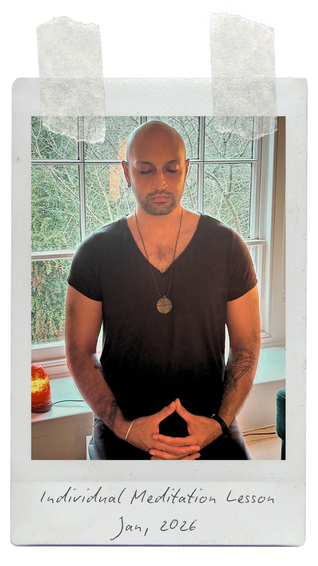 A man with a shaved head and tattoos on his arms is sitting with his eyes closed, meditating with his hands resting in his lap, fingers touching. He is wearing a black V-neck shirt, a necklace with a round pendant, and a wristband. The background shows a window with a view of barren trees outside. There is a small lamp on the windowsill. Handwritten text at the bottom reads: "Individual Meditation Lesson Jan, 2026."